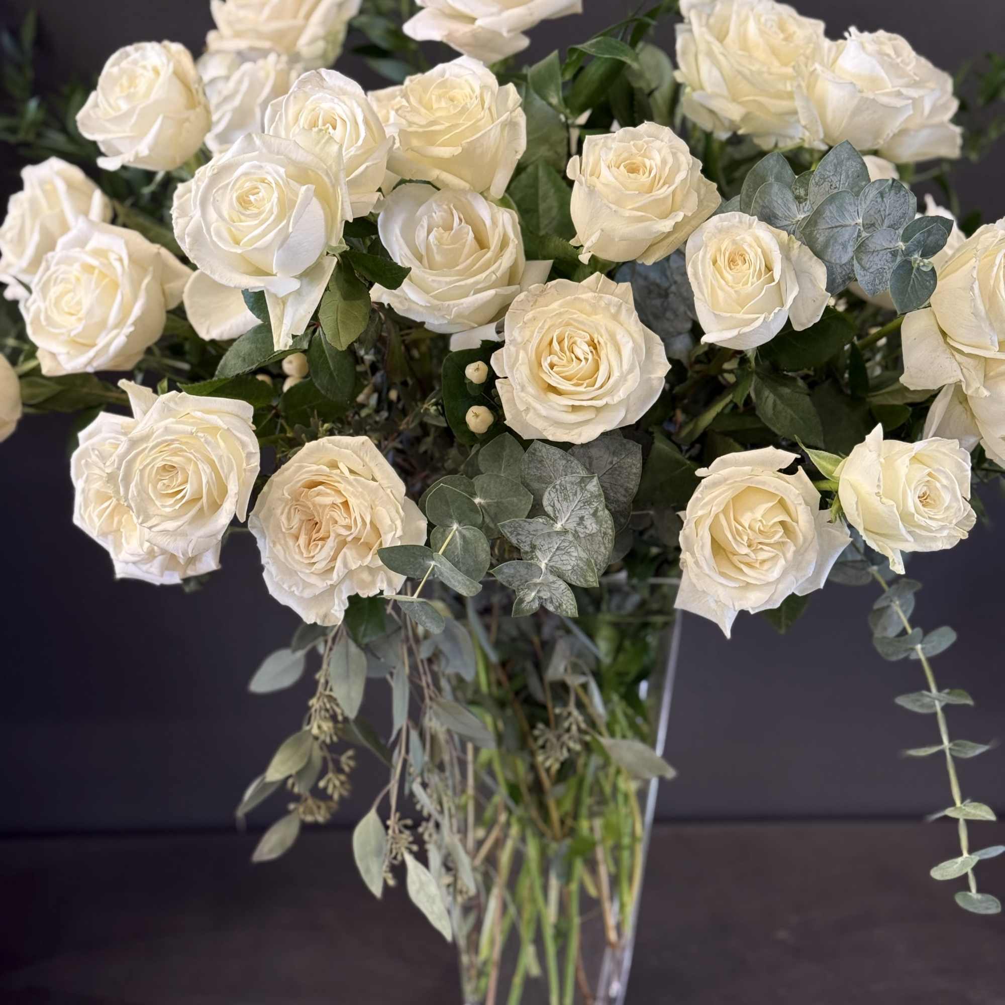 This luxurious arrangement of gorgeous roses, premium greens and other beautiful blooms