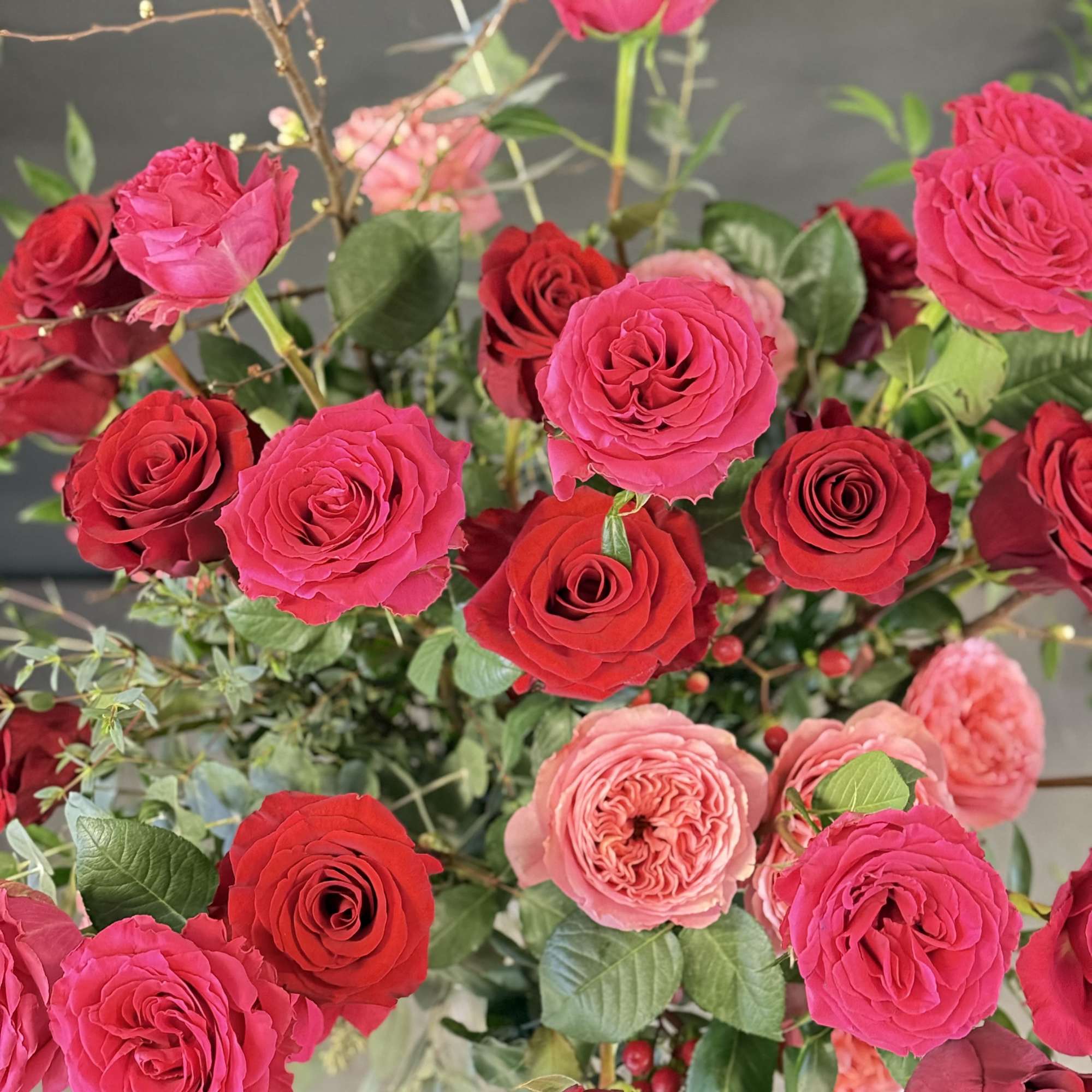 This luxurious arrangement of gorgeous roses, premium greens and other beautiful blooms