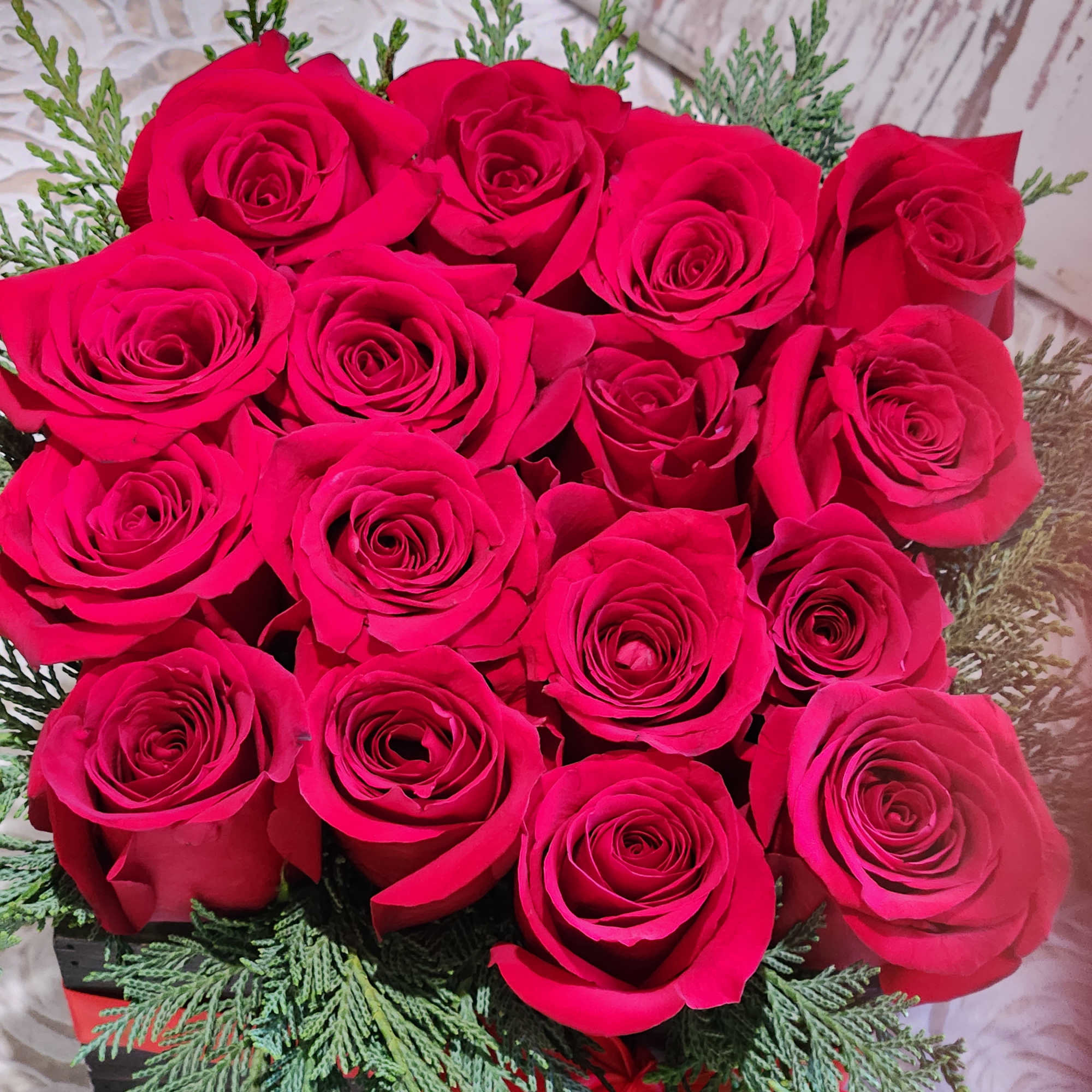 This eye-catching arrangement offers a modern twist on the classic dozen. Rustic