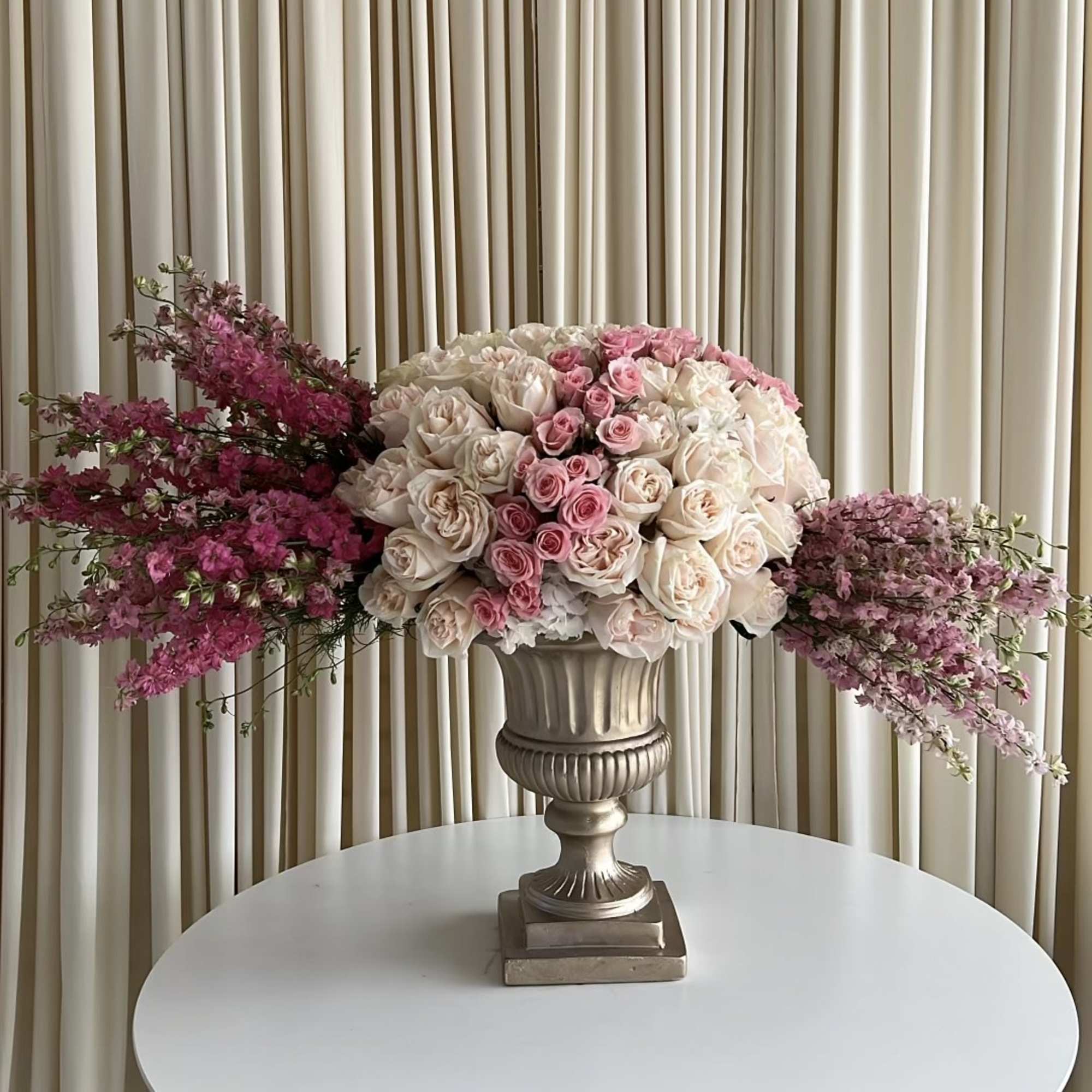 An elegant arrangement with different shades of pink in a stunning gold
