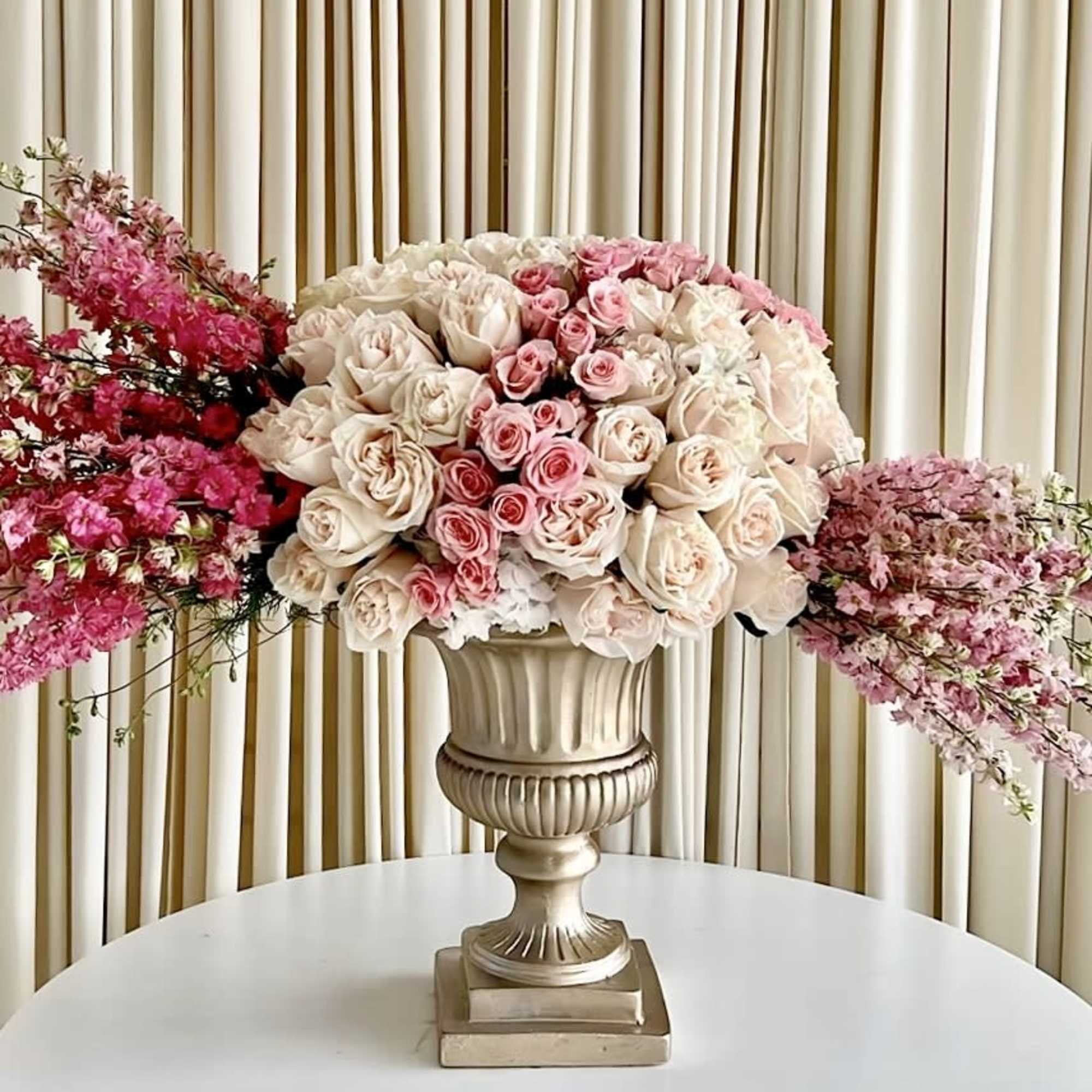 An elegant arrangement with different shades of pink in a stunning gold
