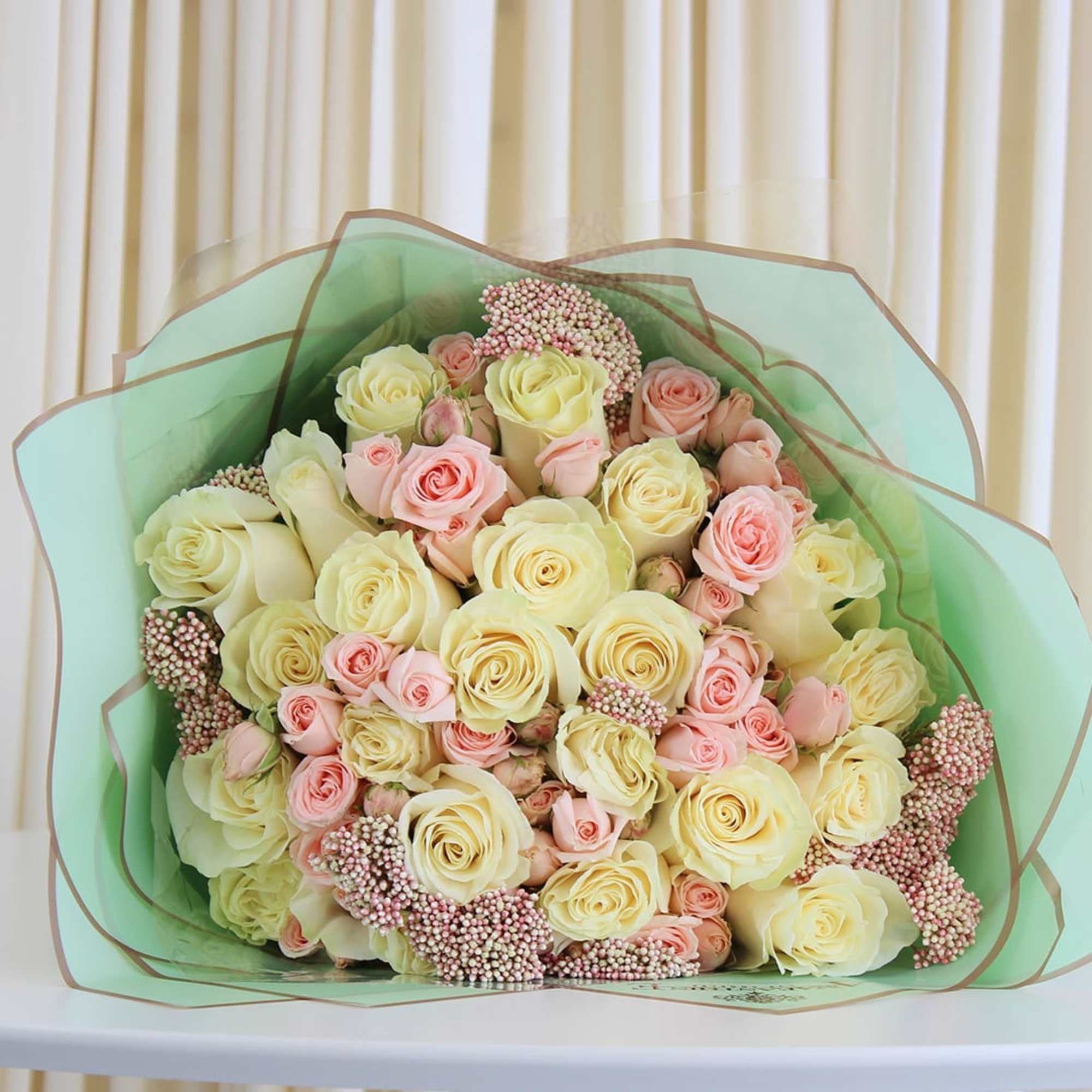 This exquisite bouquet showcases the timeless beauty of white and pink roses