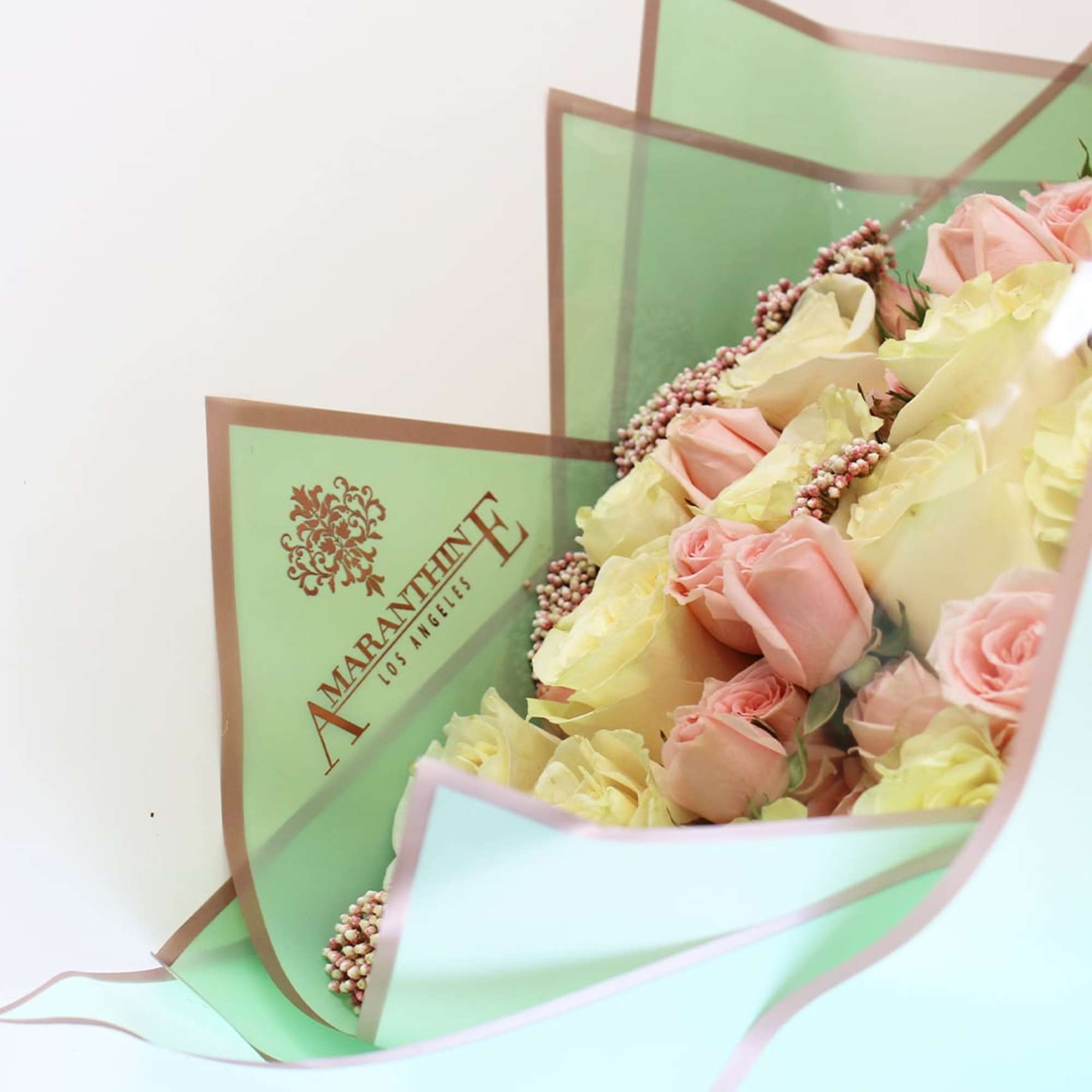 This exquisite bouquet showcases the timeless beauty of white and pink roses