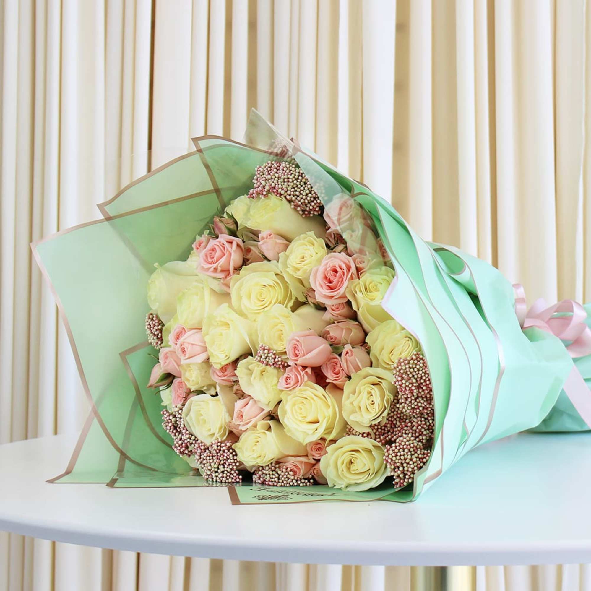 This exquisite bouquet showcases the timeless beauty of white and pink roses