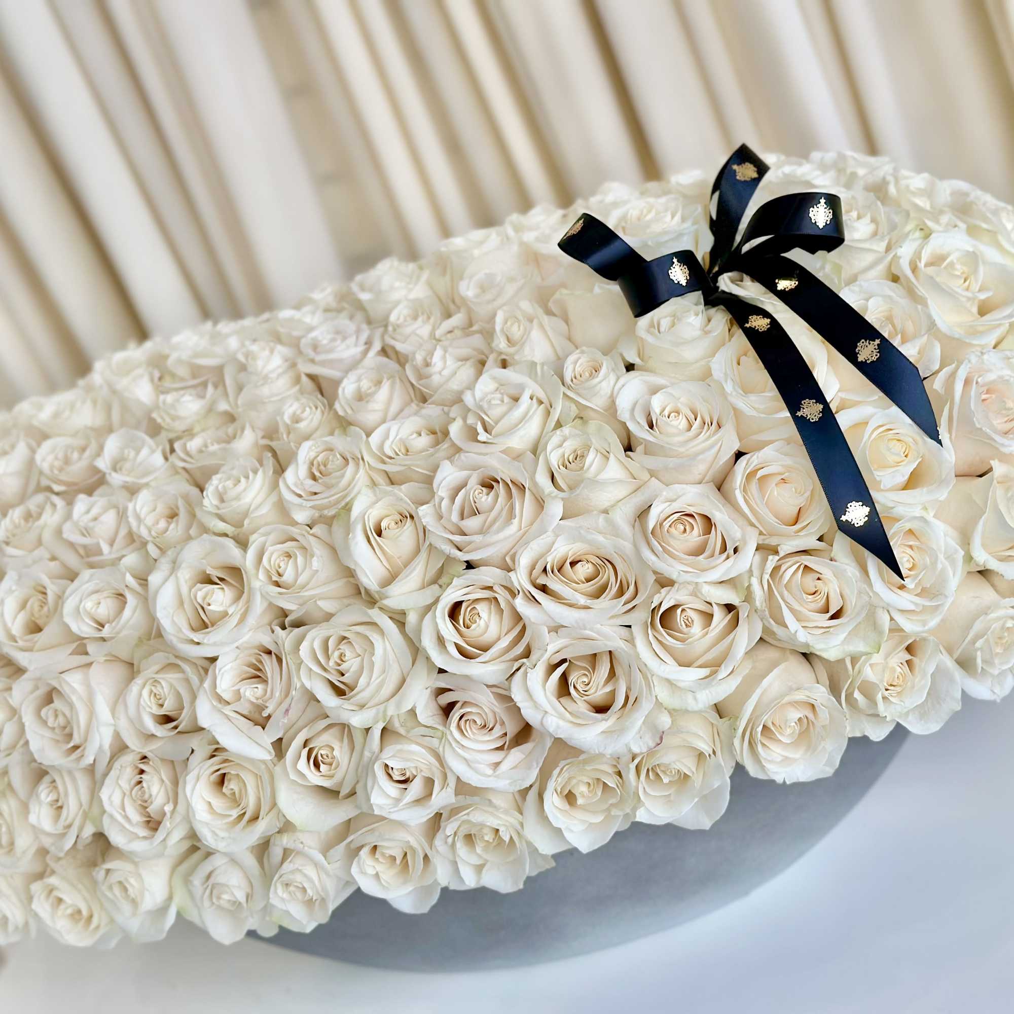 Experience the enchanting allure of our &quot;Whispering Petals&quot; White Rose Arrangement. Delicate