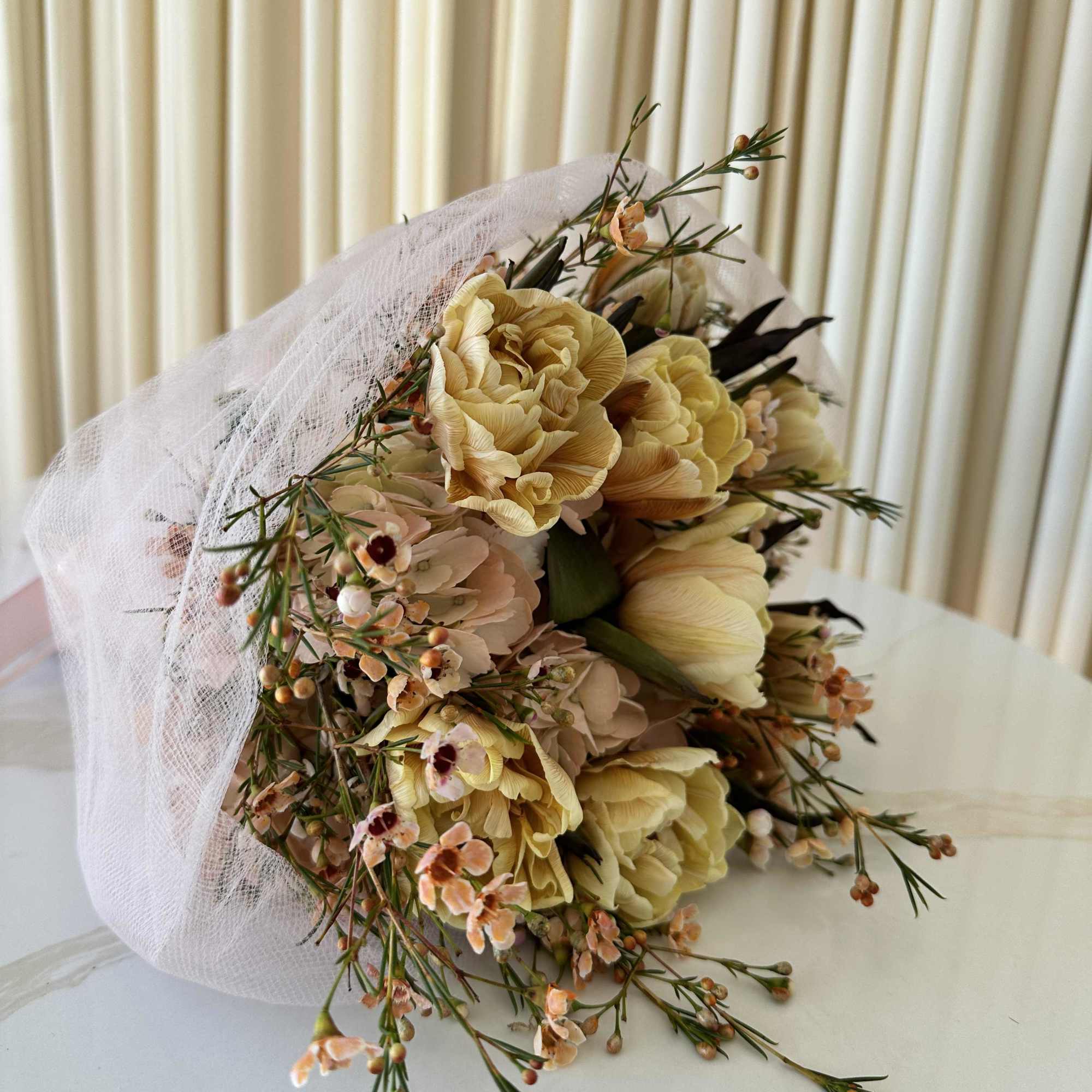 Soft and graceful, this bouquet of tulips, colored in delicate shades of