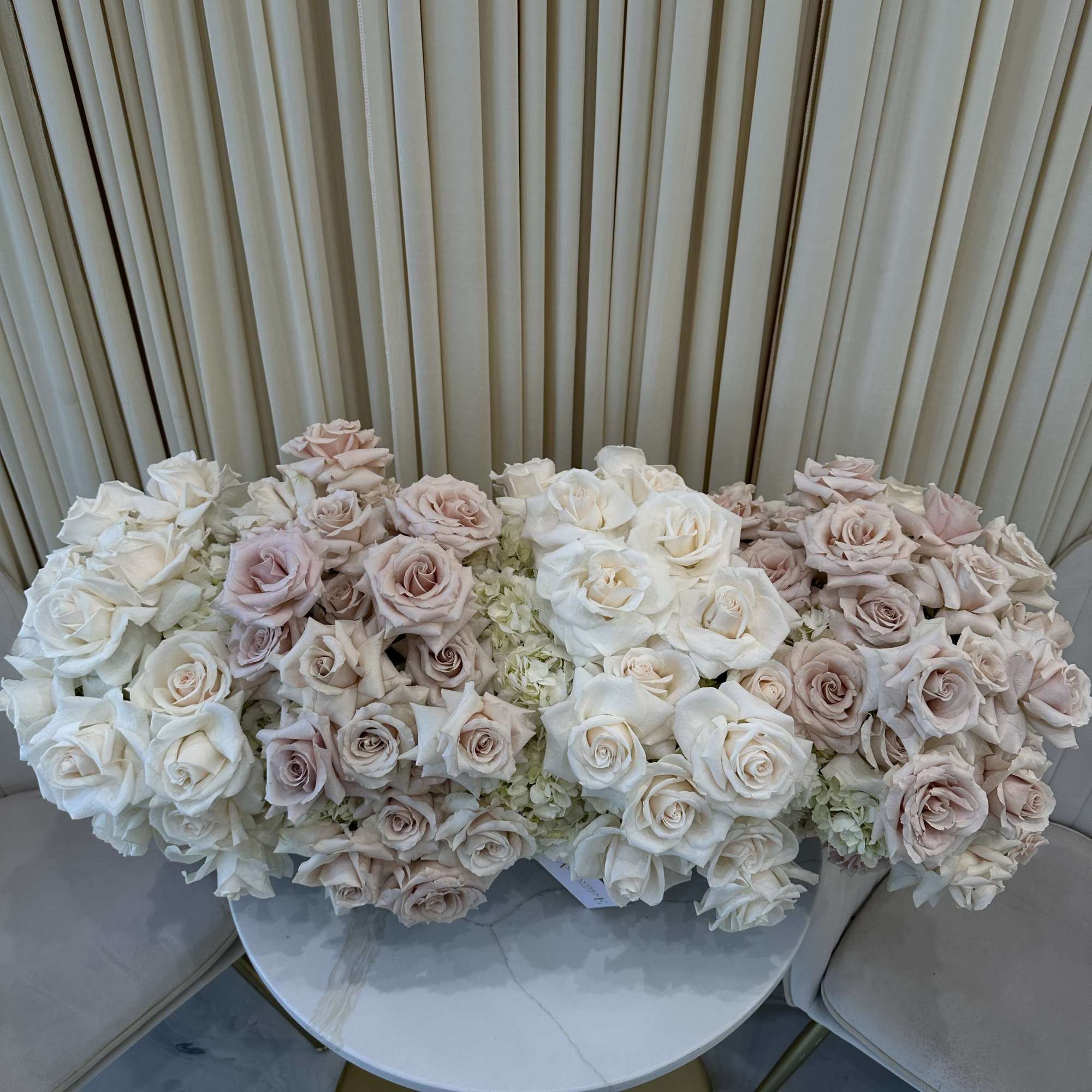 Symbolize purity and love with this classic bouquet of white and blush
