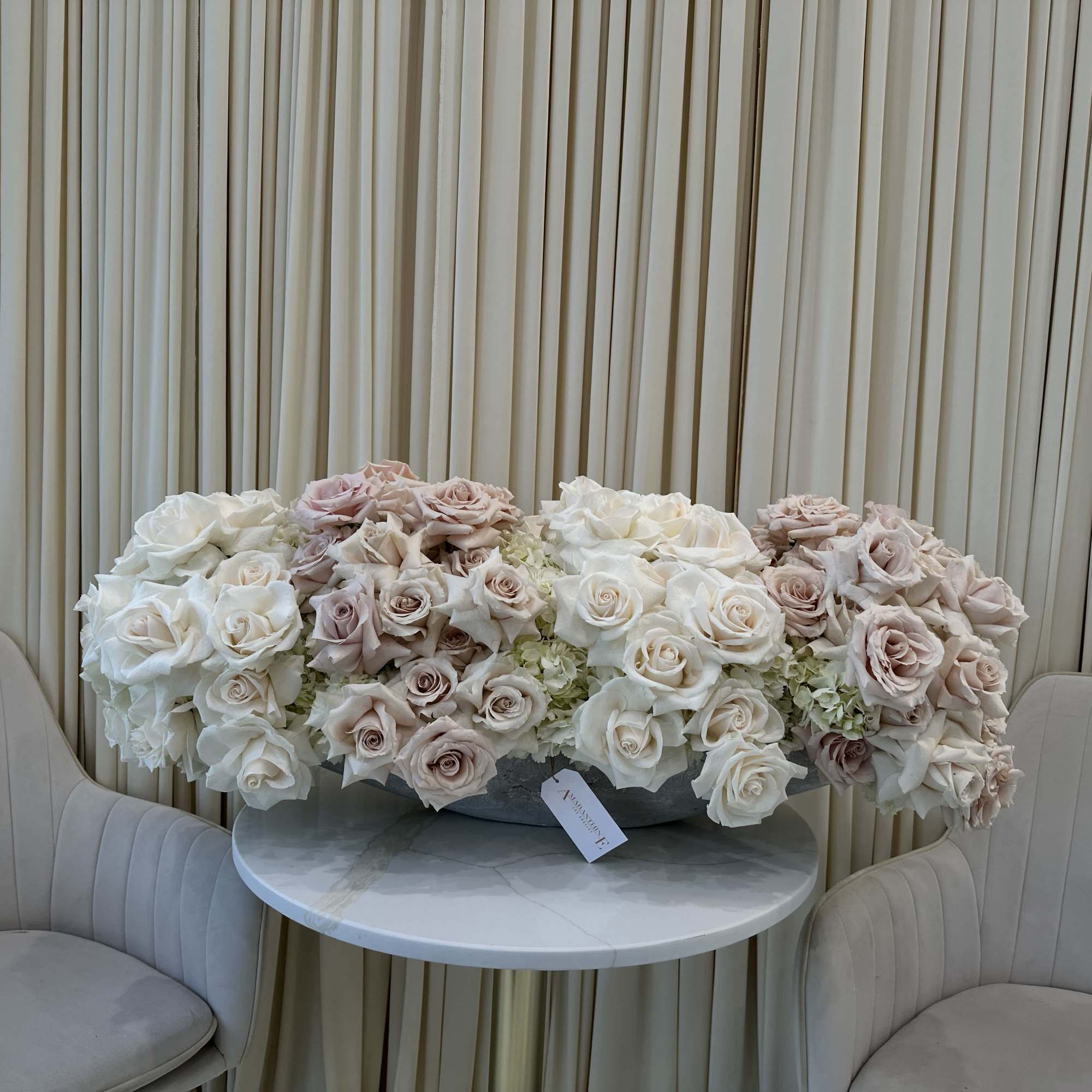 Symbolize purity and love with this classic bouquet of white and blush