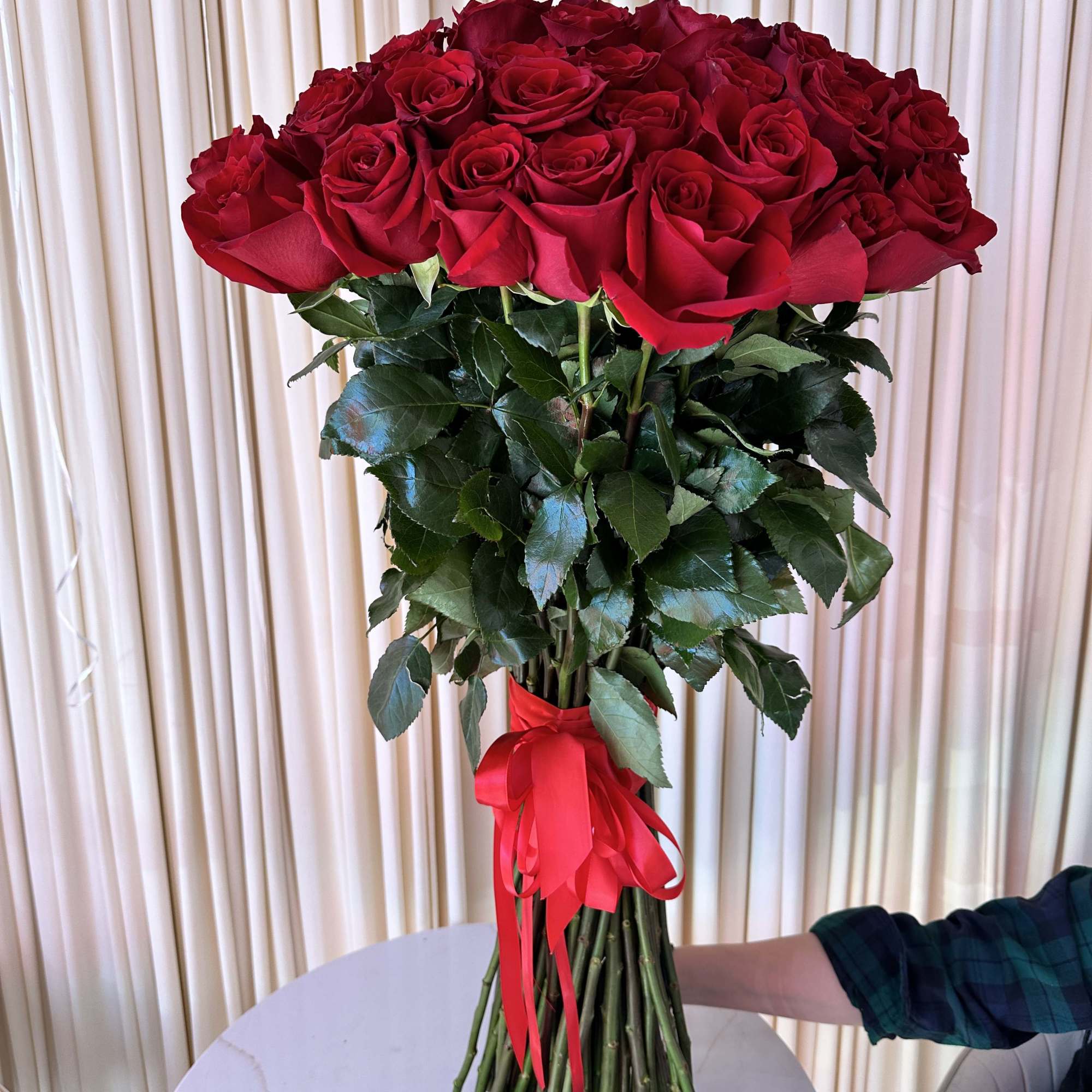 Celebrate love&#039;s symphony with this breathtaking bouquet of 50 radiant red roses.