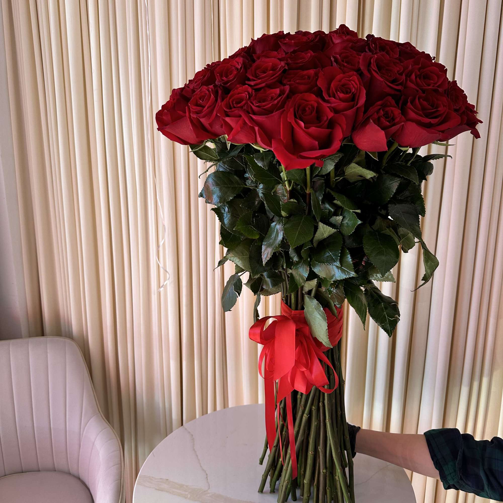 Celebrate love&#039;s symphony with this breathtaking bouquet of 50 radiant red roses.