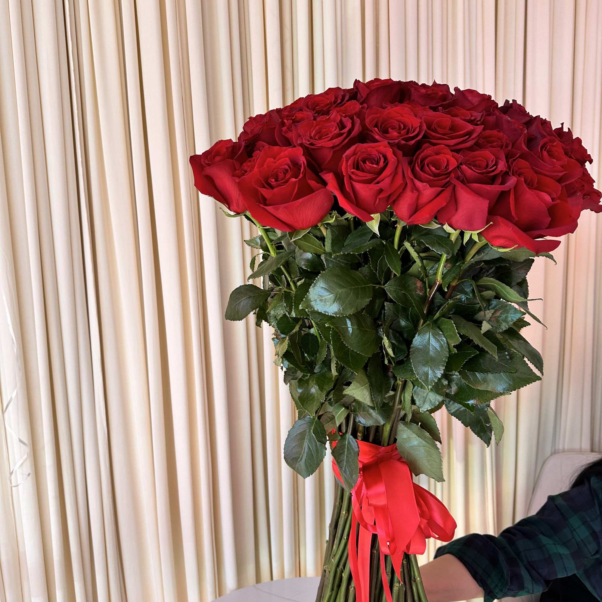Celebrate love&#039;s symphony with this breathtaking bouquet of 50 radiant red roses.