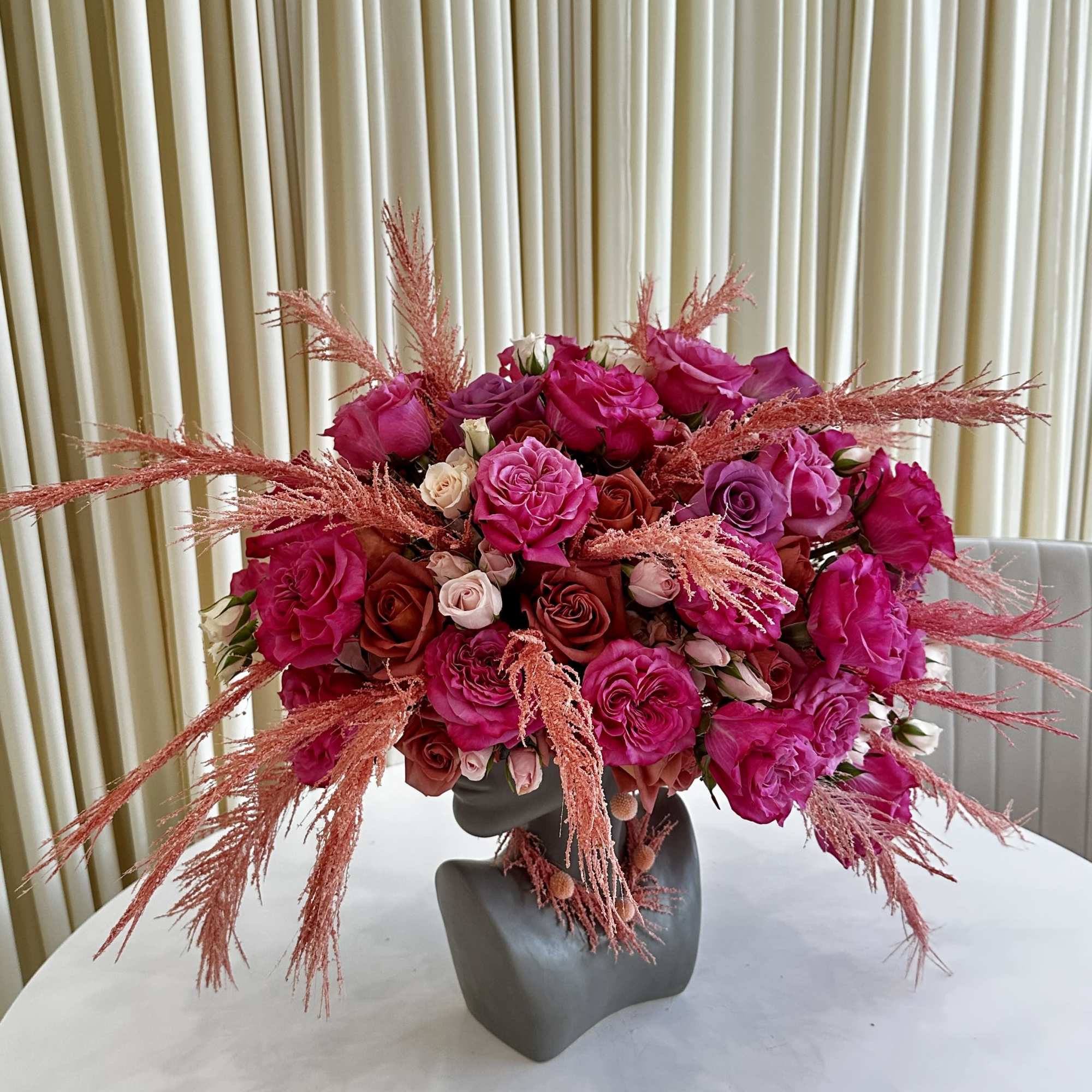 Experience the allure of &quot;Vibrant Splendor,&quot; a head-shaped flower arrangement that embraces