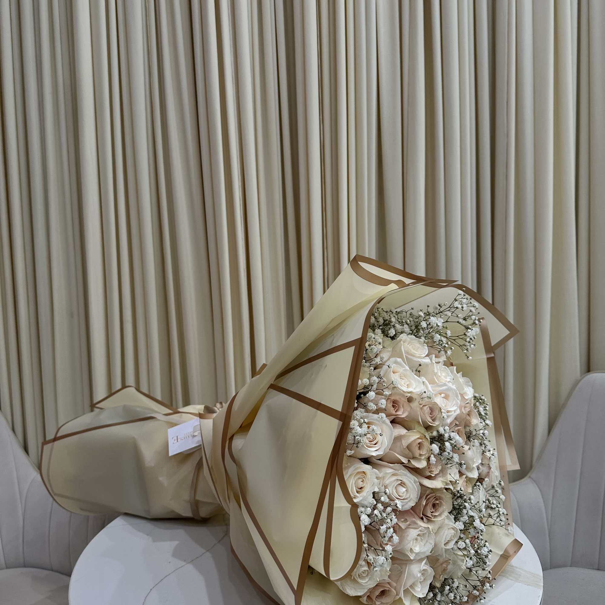 This delicate bouquet features 50 roses with soft baby&#039;s breath accents. The