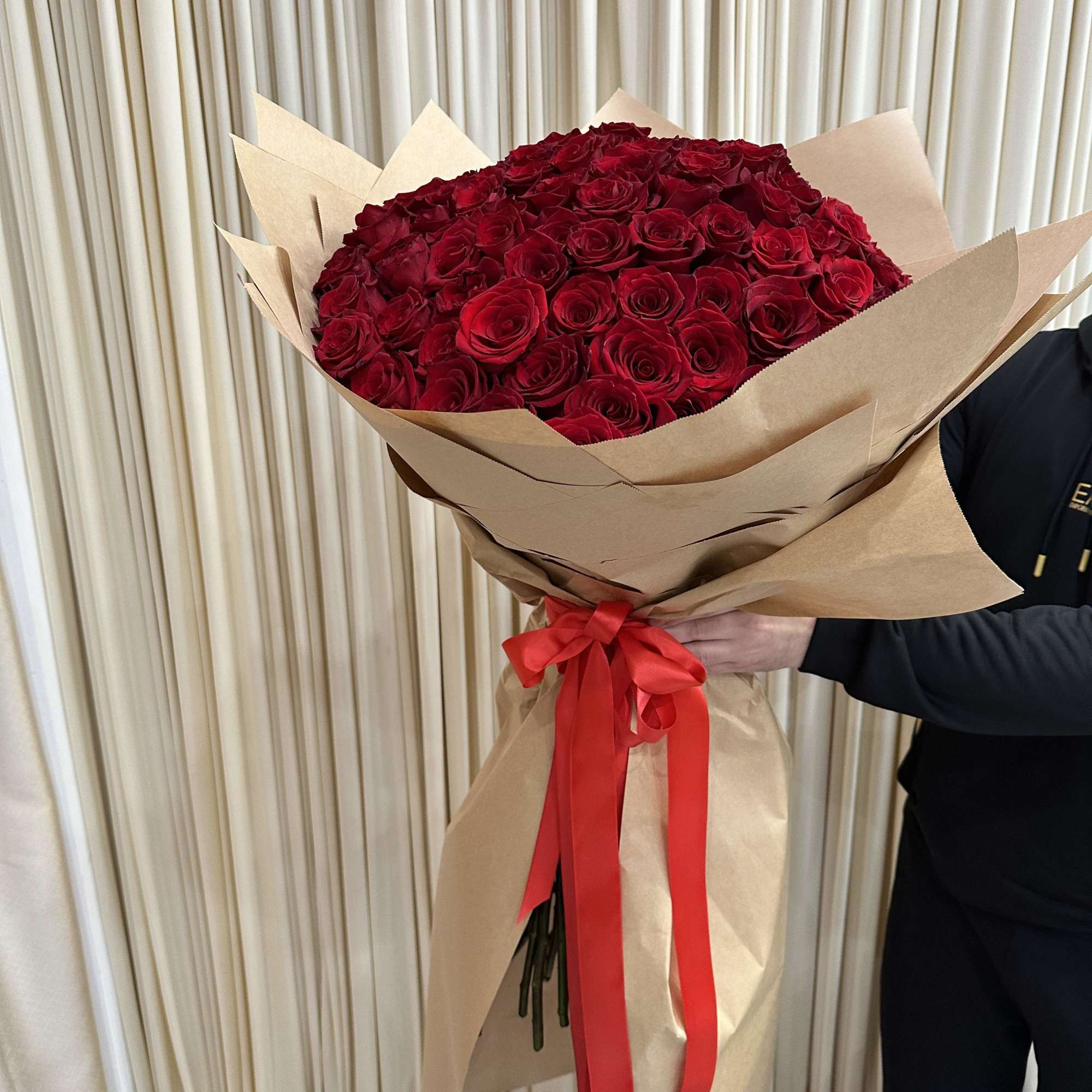 Wrapped in a cascading dress style, this dramatic bouquet of 150 