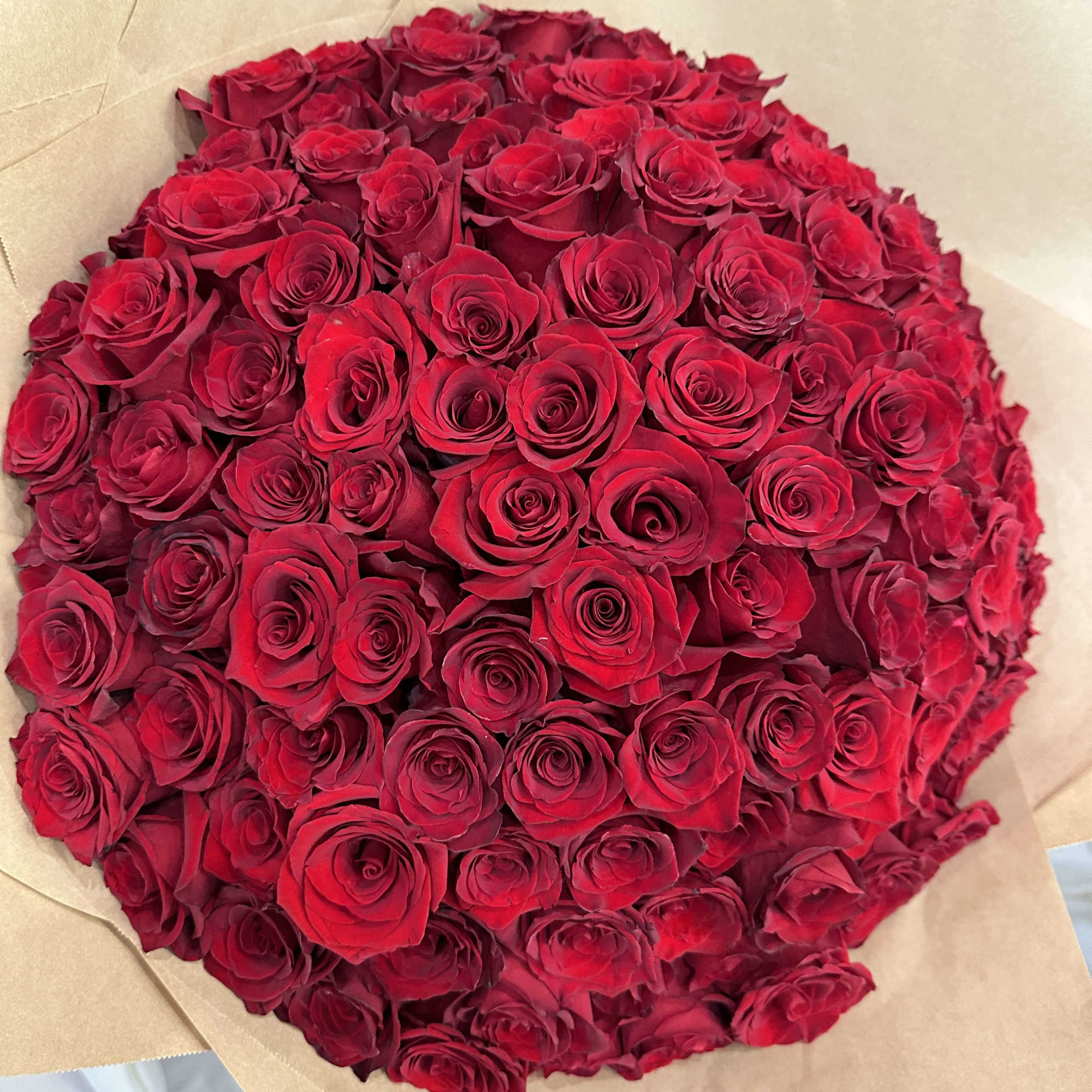 Wrapped in a cascading dress style, this dramatic bouquet of 150 