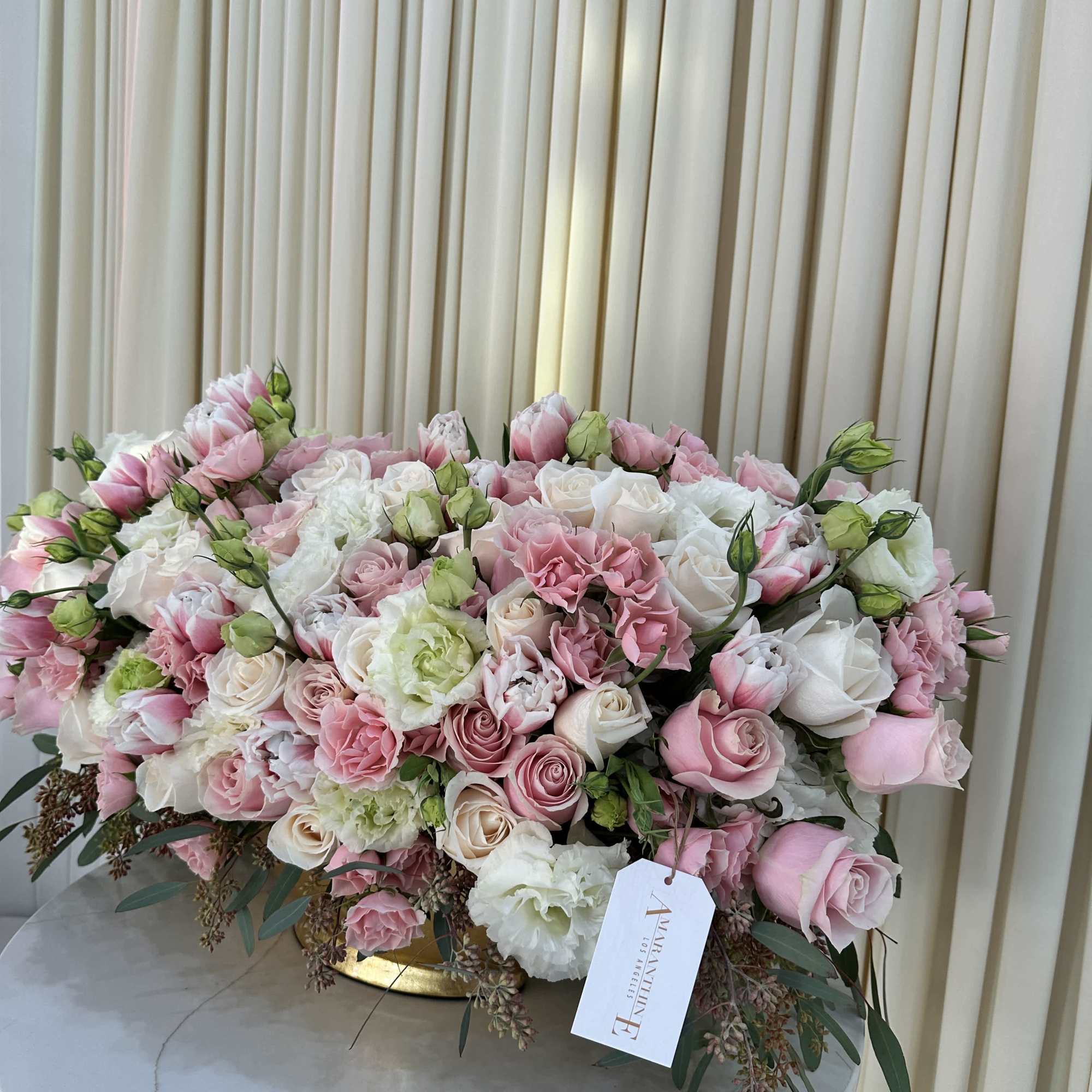 This stunning bouquet features a vibrant mix of pink and white roses