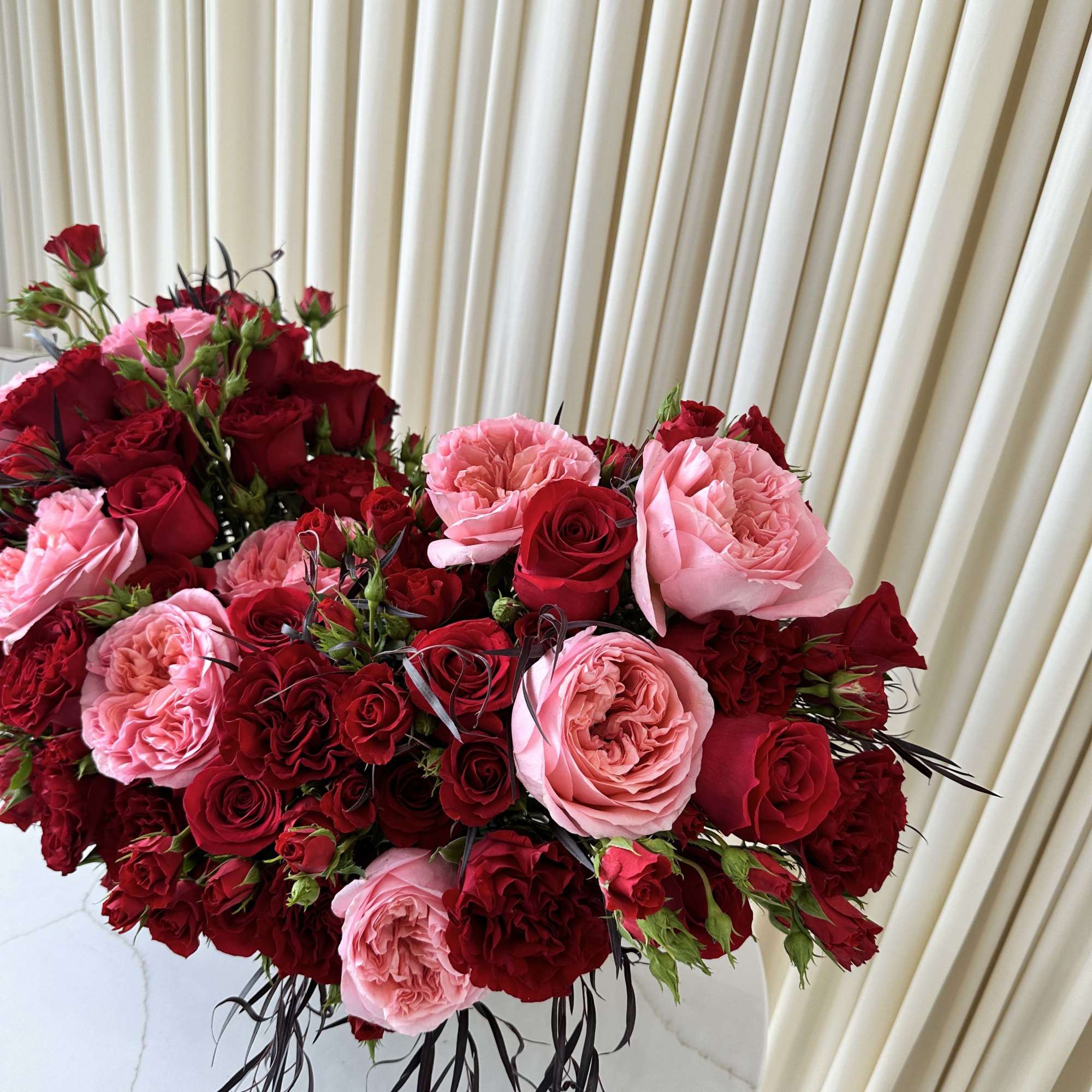 Infuse any occasion with timeless beauty with this breathtaking arrangement of red