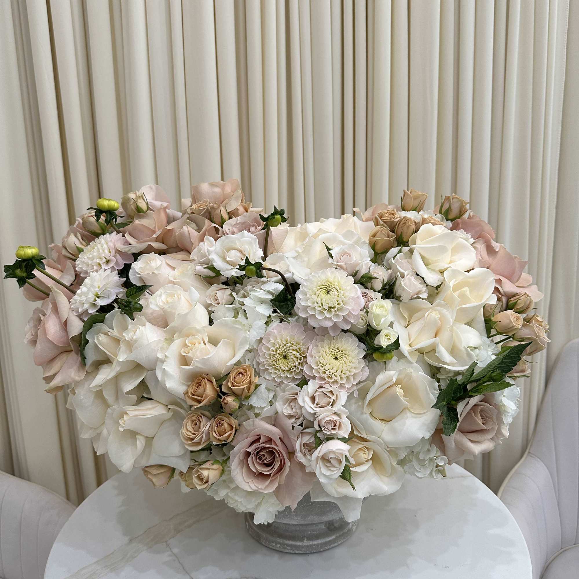 This breathtaking arrangement is overflowing with vibrant blooms, perfect for celebrating a