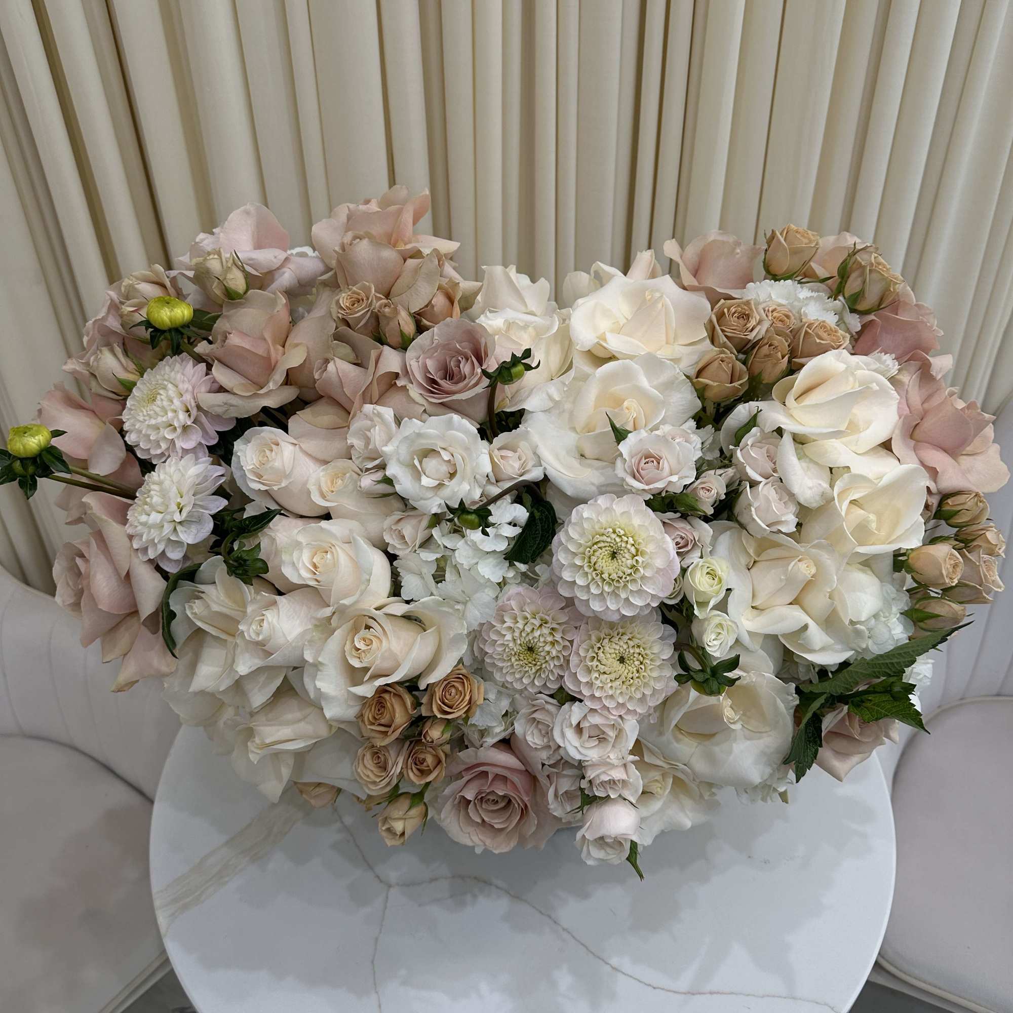 This breathtaking arrangement is overflowing with vibrant blooms, perfect for celebrating a