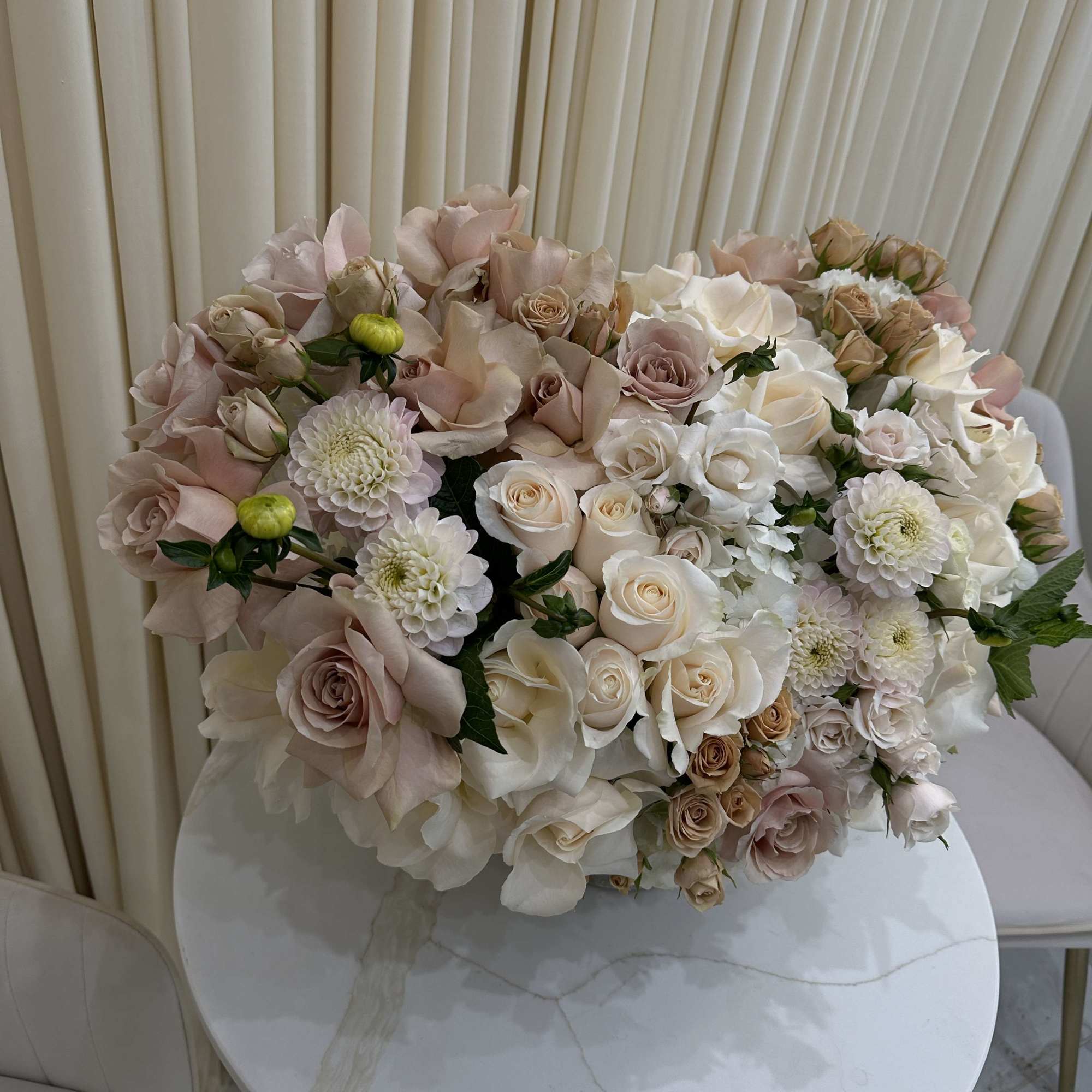 This breathtaking arrangement is overflowing with vibrant blooms, perfect for celebrating a