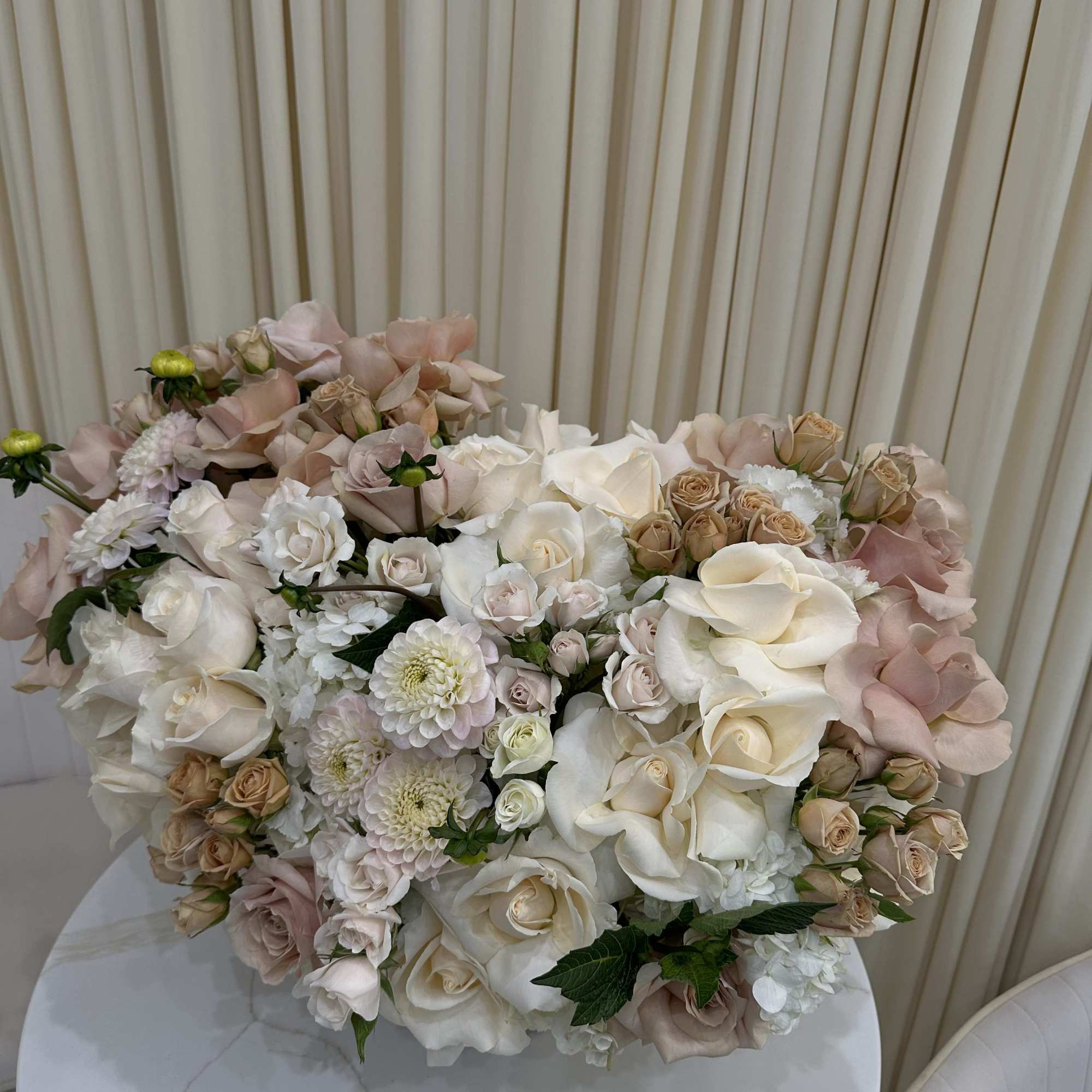 This breathtaking arrangement is overflowing with vibrant blooms, perfect for celebrating a