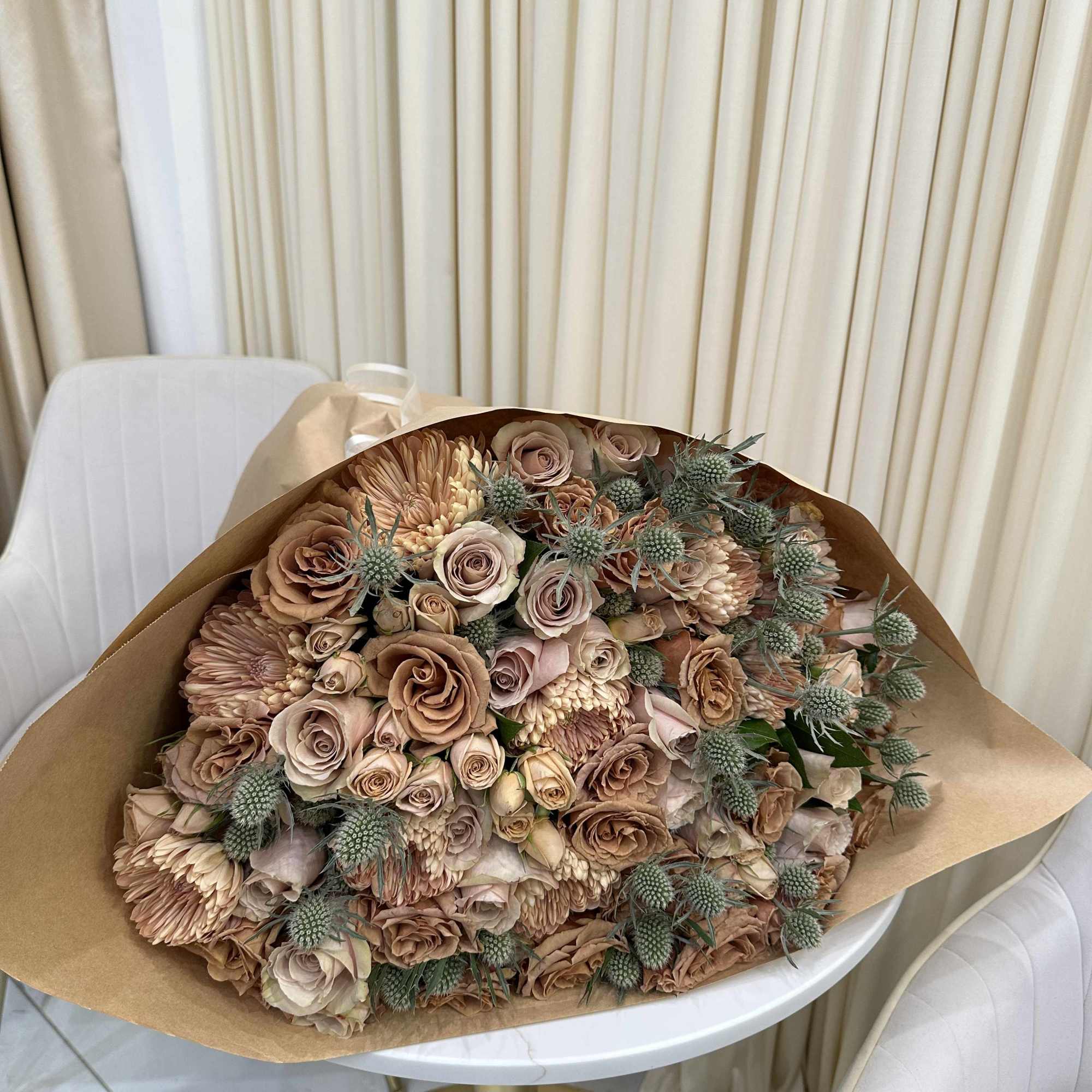 This beautiful bouquet features a mix of seasonal blooms in soft, muted