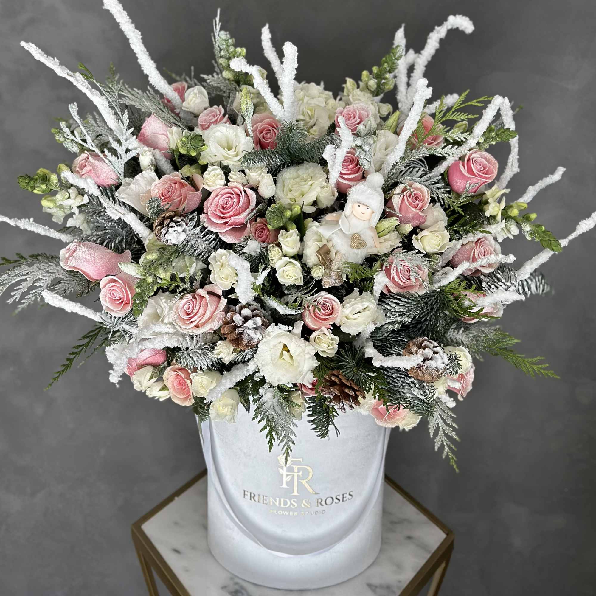 Our white signature box holds a stunning holiday arrangement with premium flowers