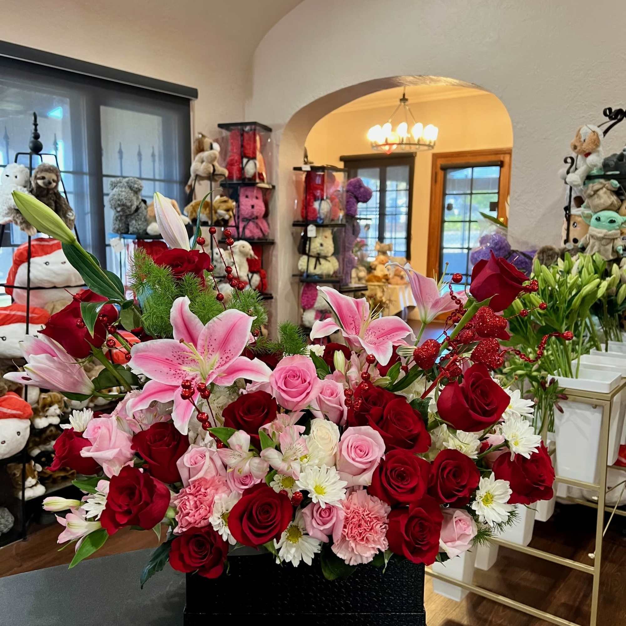 A mixed of red white and pink flowers arranged inside a rectangular