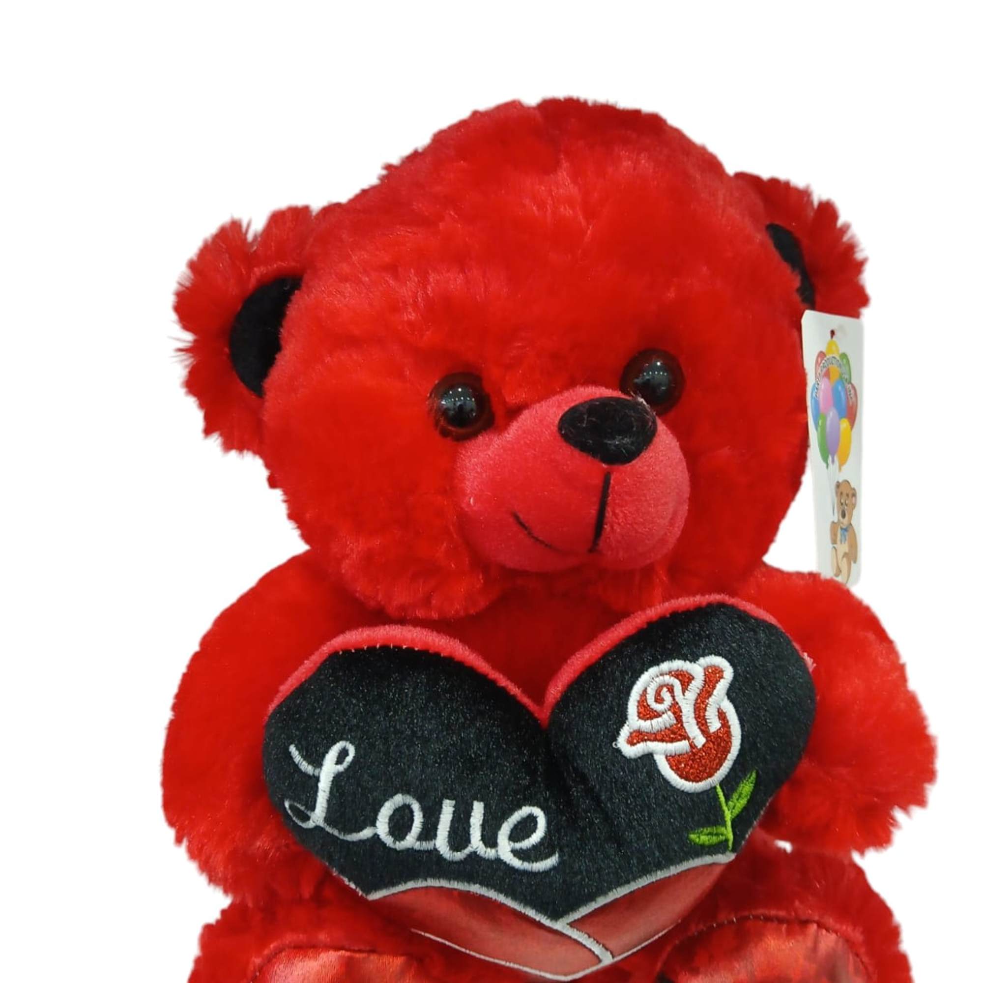 This adorable red teddy bear holds a shiny heart with the message This adorable red teddy bear holds a shiny heart with the message
