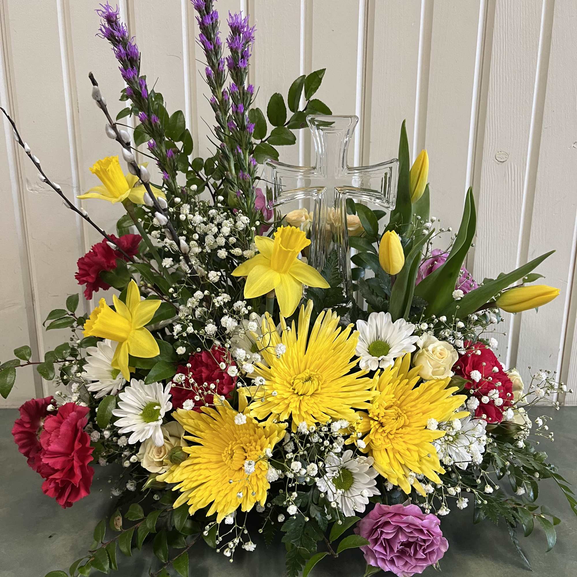 Springy color assortment of fresh flowers with a keepsake crystal cross. Springy color assortment of fresh flowers with a keepsake crystal cross.