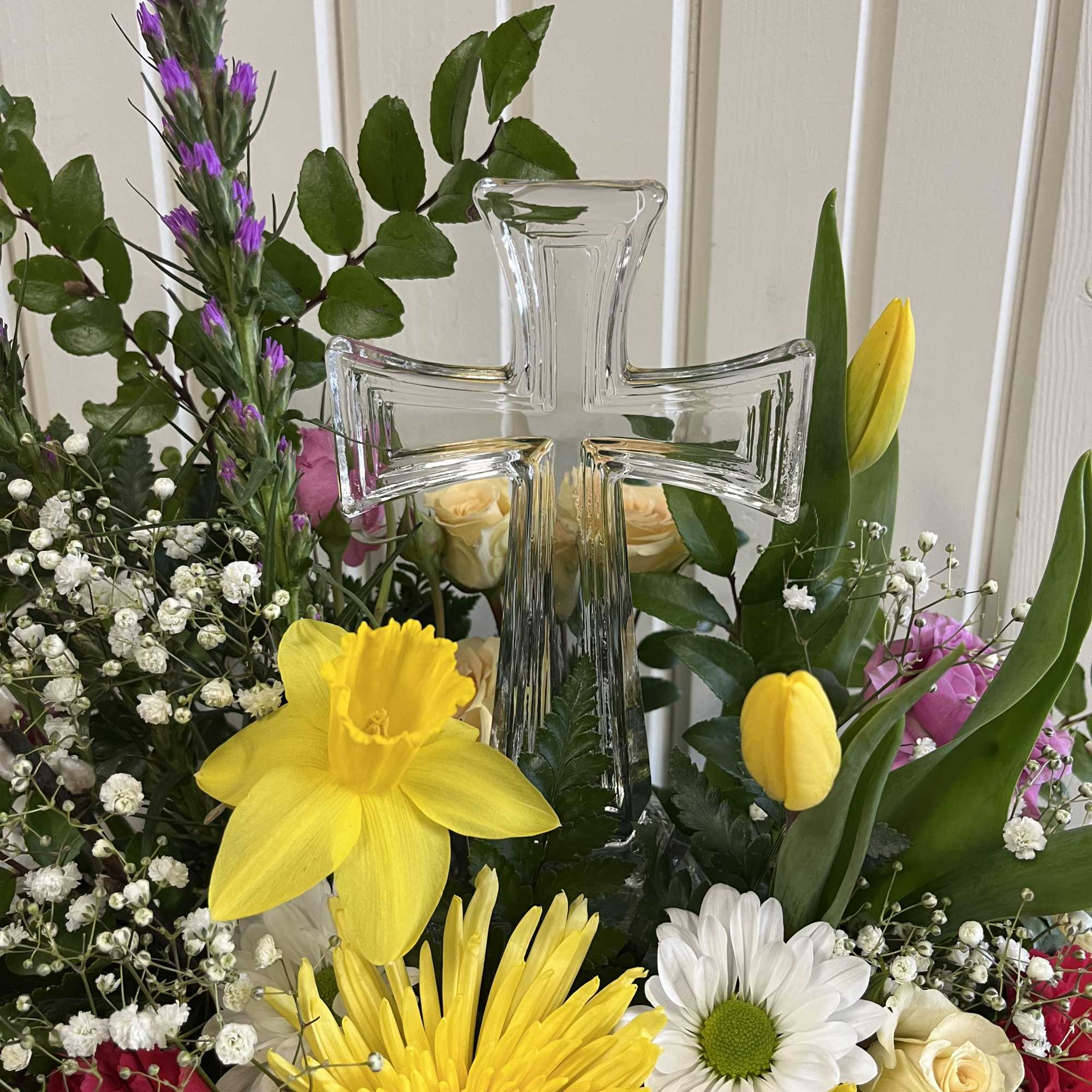 Springy color assortment of fresh flowers with a keepsake crystal cross. Springy color assortment of fresh flowers with a keepsake crystal cross.