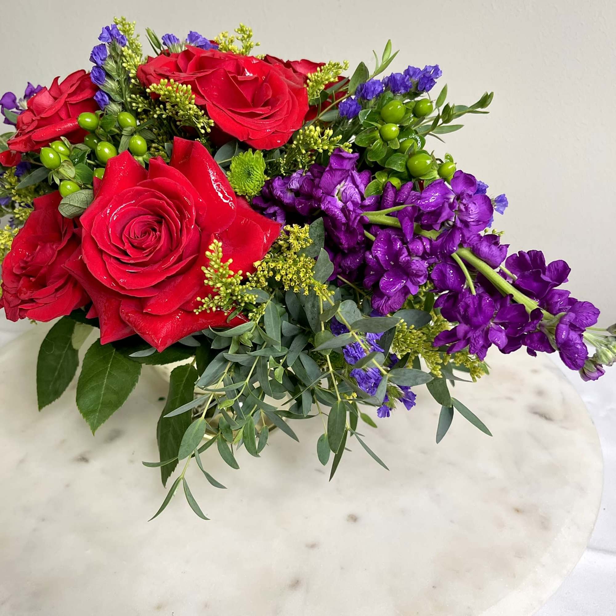 An ethereal rose arrangement. The dramatically beautiful sprays of deep purple give An ethereal rose arrangement. The dramatically beautiful sprays of deep purple give