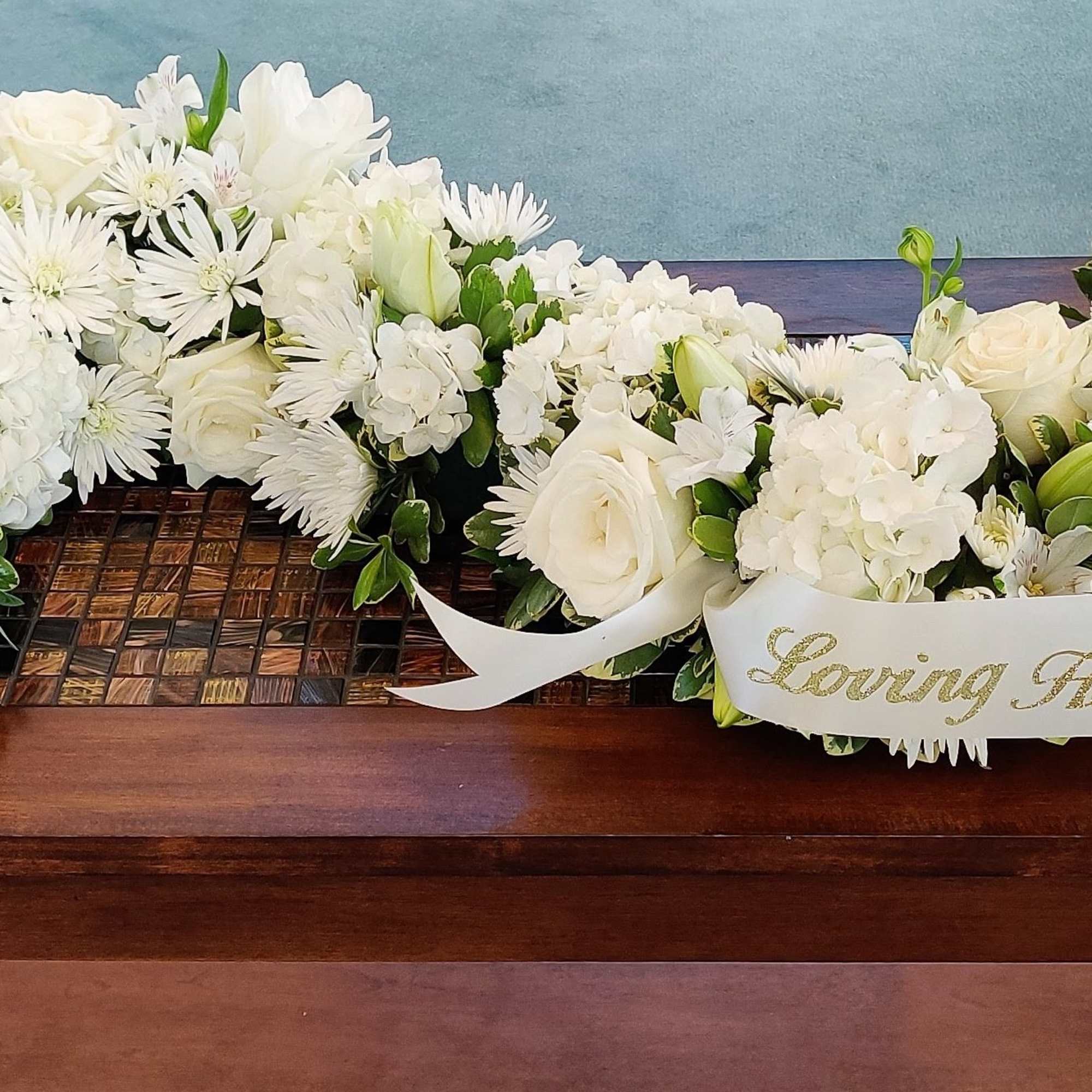 Our signature S-Shaped Urn Surround arrangement made with elegant mixed blooms in Our signature S-Shaped Urn Surround arrangement made with elegant mixed blooms in