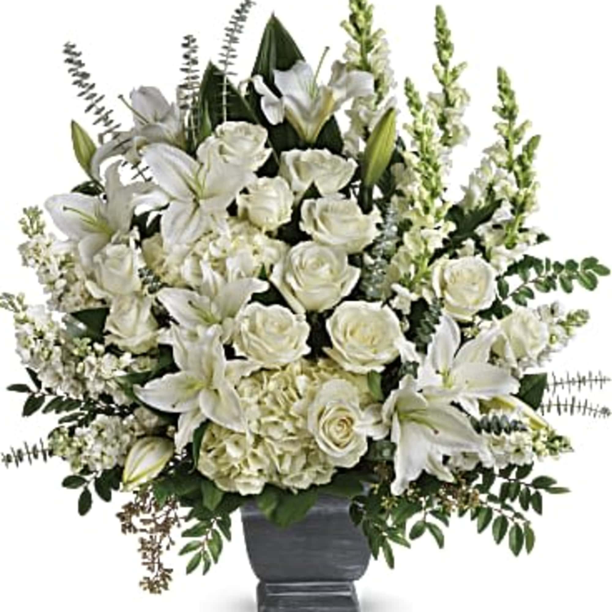 This magnificent bouquet of classic all-white flowers in a graceful Grecian urn