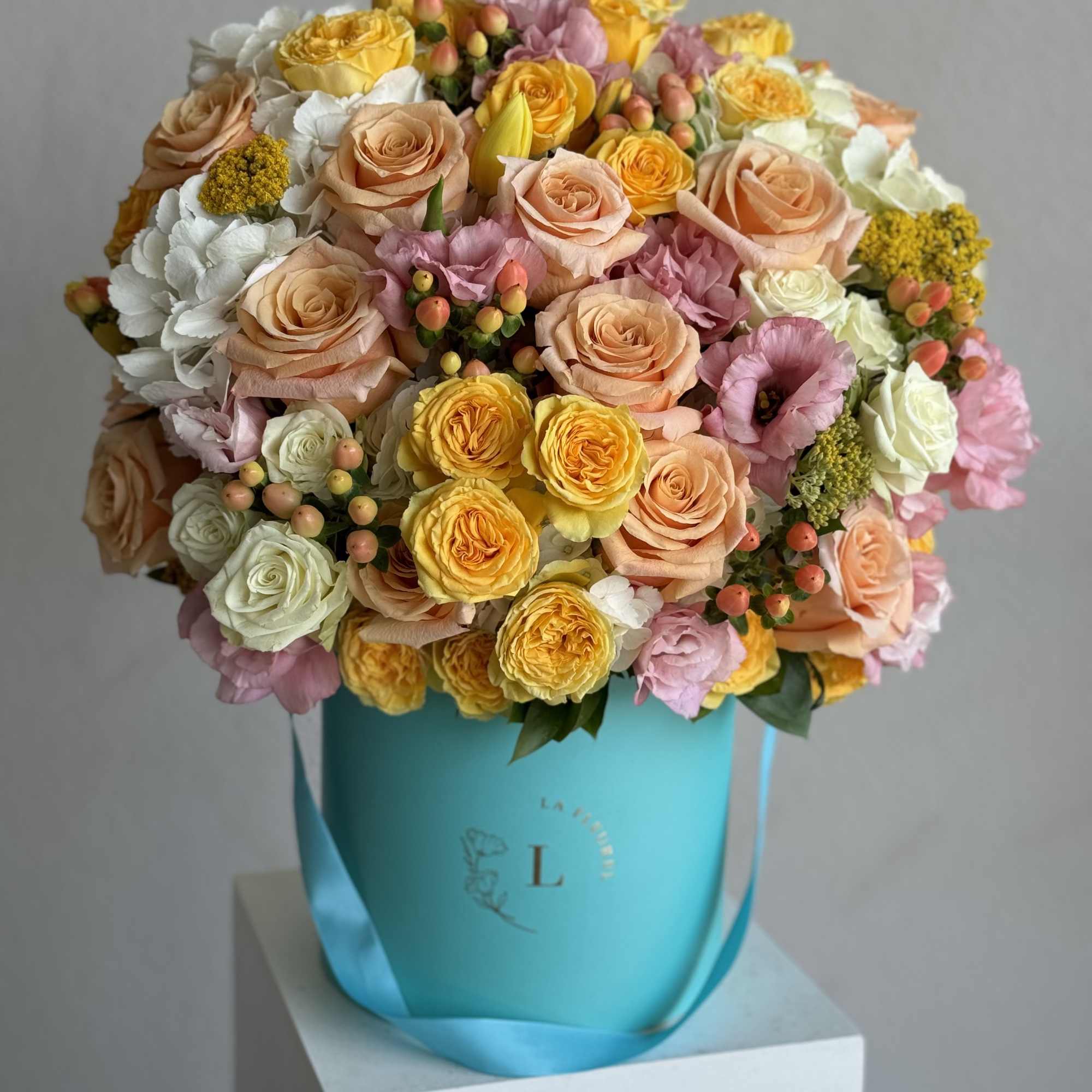  A cheerful arrangement featuring vibrant yellow roses, lush hydrangeas, aromatic coffee