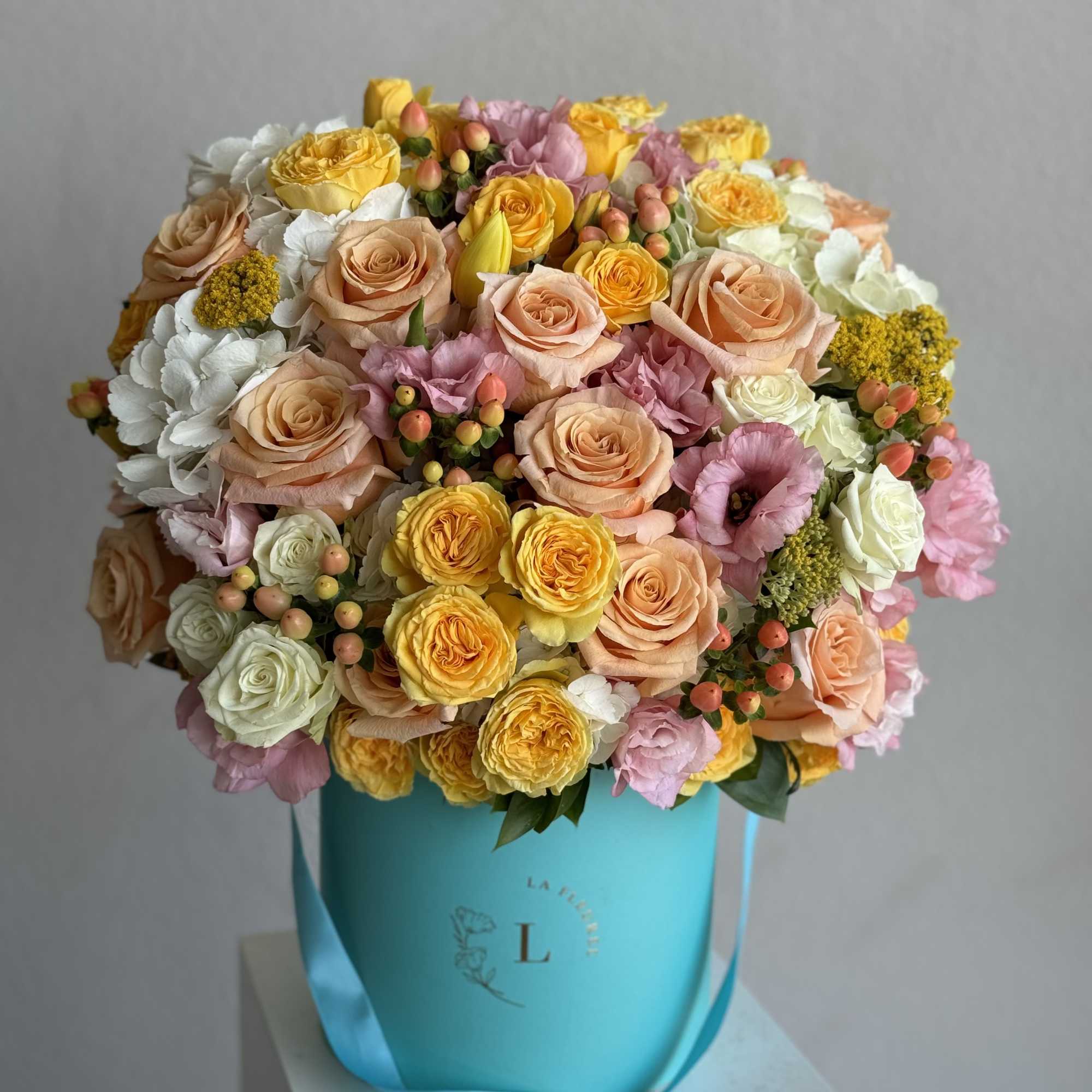  A cheerful arrangement featuring vibrant yellow roses, lush hydrangeas, aromatic coffee