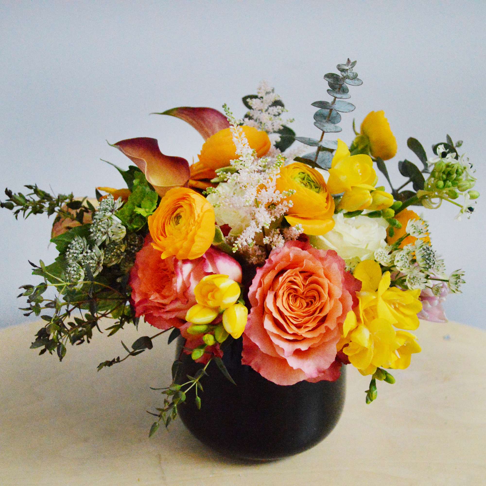 This arrangement is presented in a pinched glass vase and accented by This arrangement is presented in a pinched glass vase and accented by