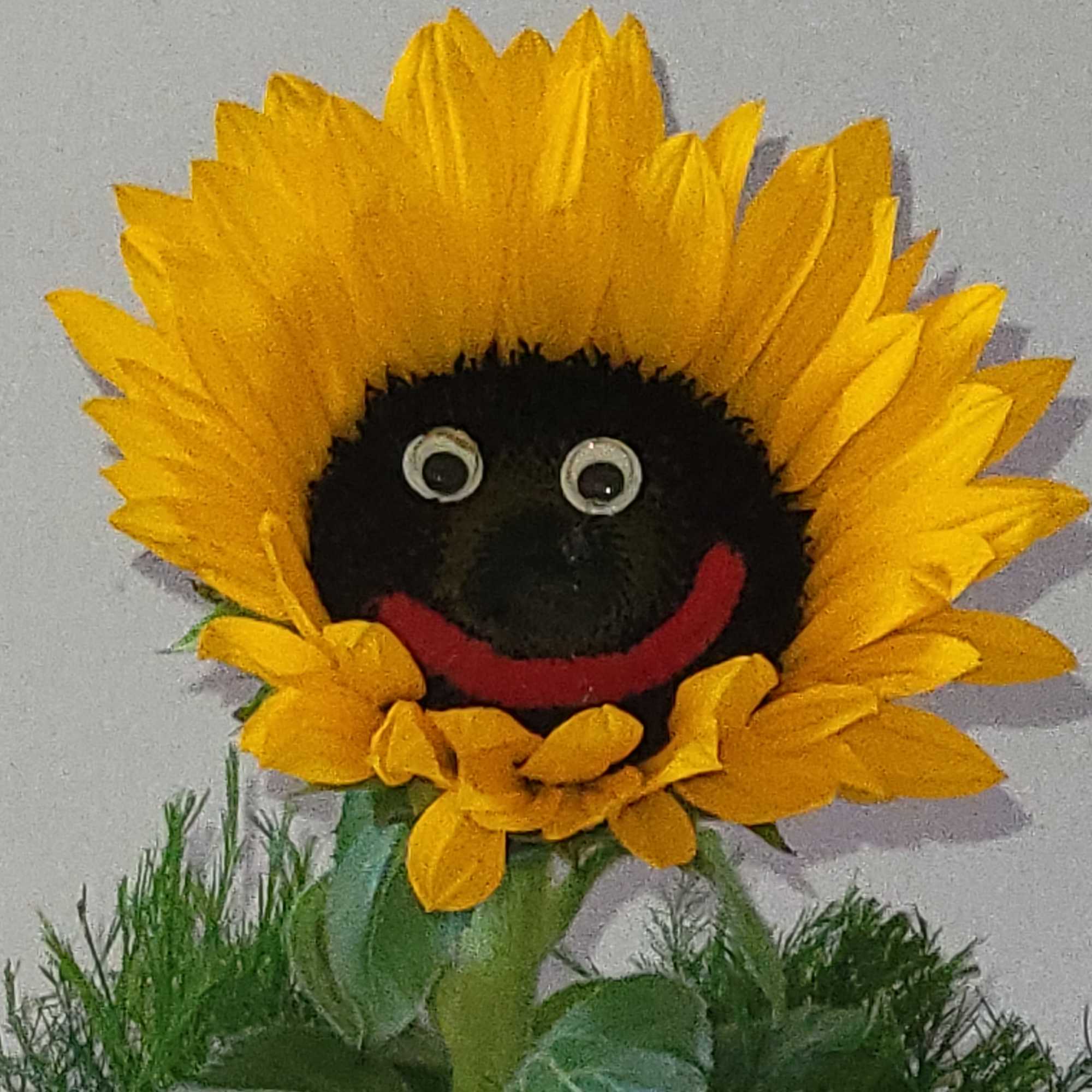 Sunflower with smiley face, tree fern and small vase. Colors of the