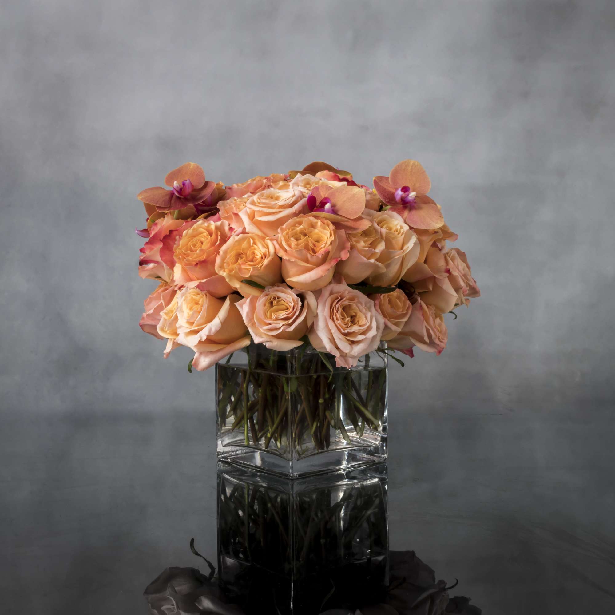 Bold and dynamic, this stunning display of Cherry Brandy roses and garden