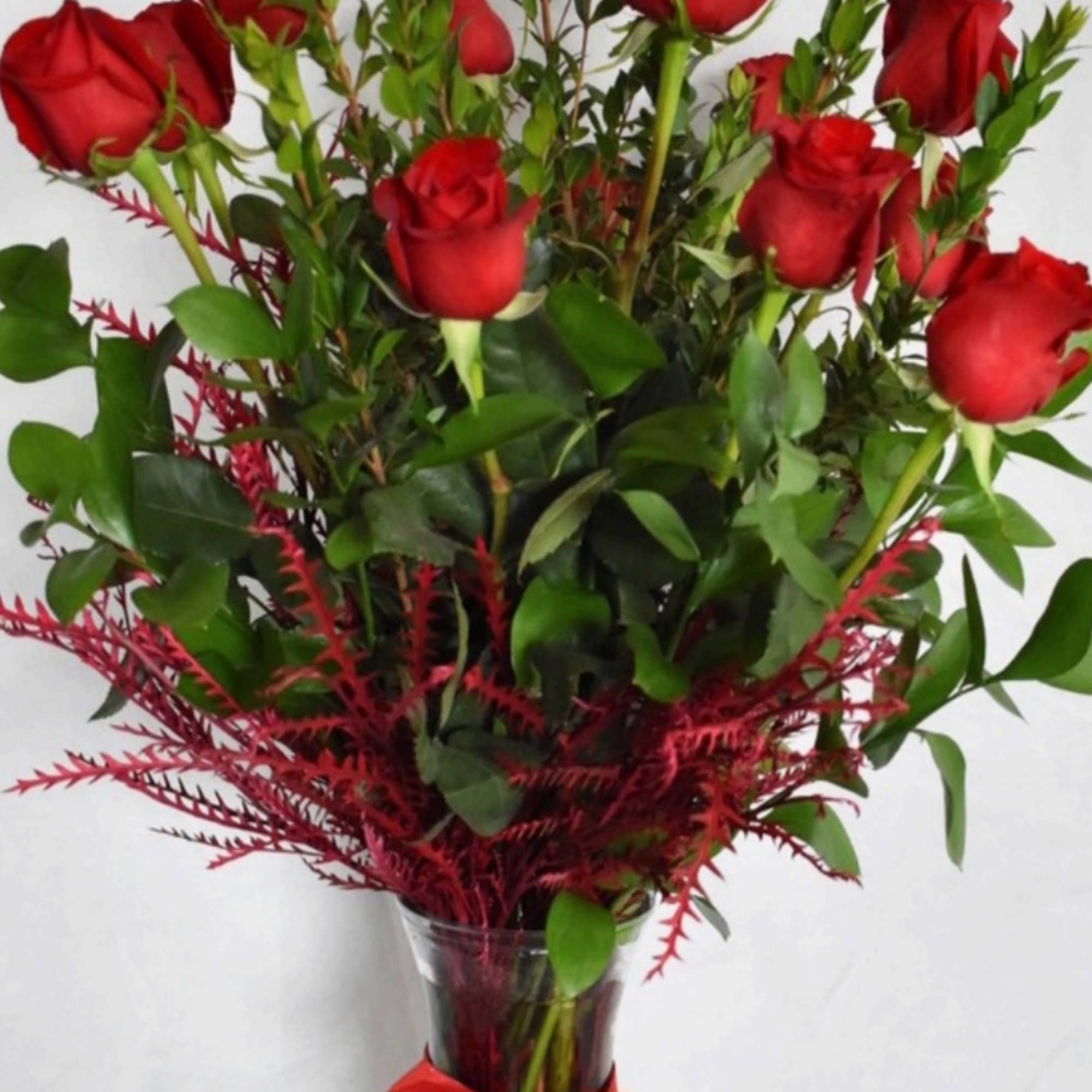 Dozen red long stem roses with premium greens and filler