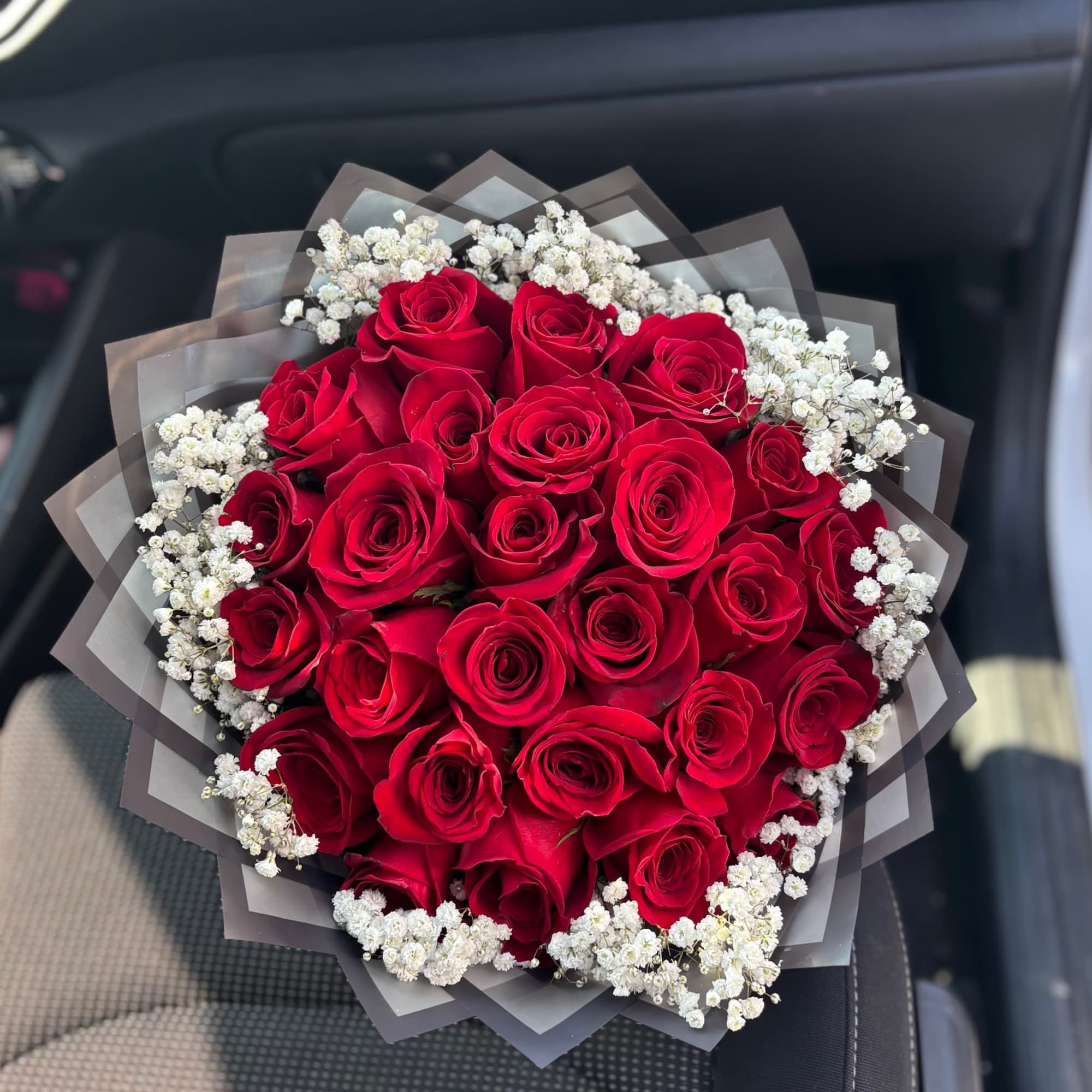 Beautiful Babies Breath wrapped around 25 red roses in a bouquet.  Beautiful Babies Breath wrapped around 25 red roses in a bouquet.