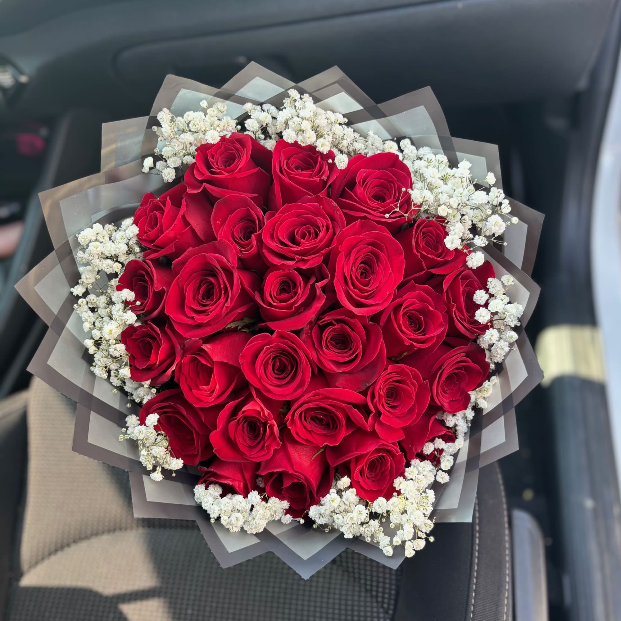 Beautiful Babies Breath wrapped around 25 red roses in a bouquet.  Beautiful Babies Breath wrapped around 25 red roses in a bouquet.