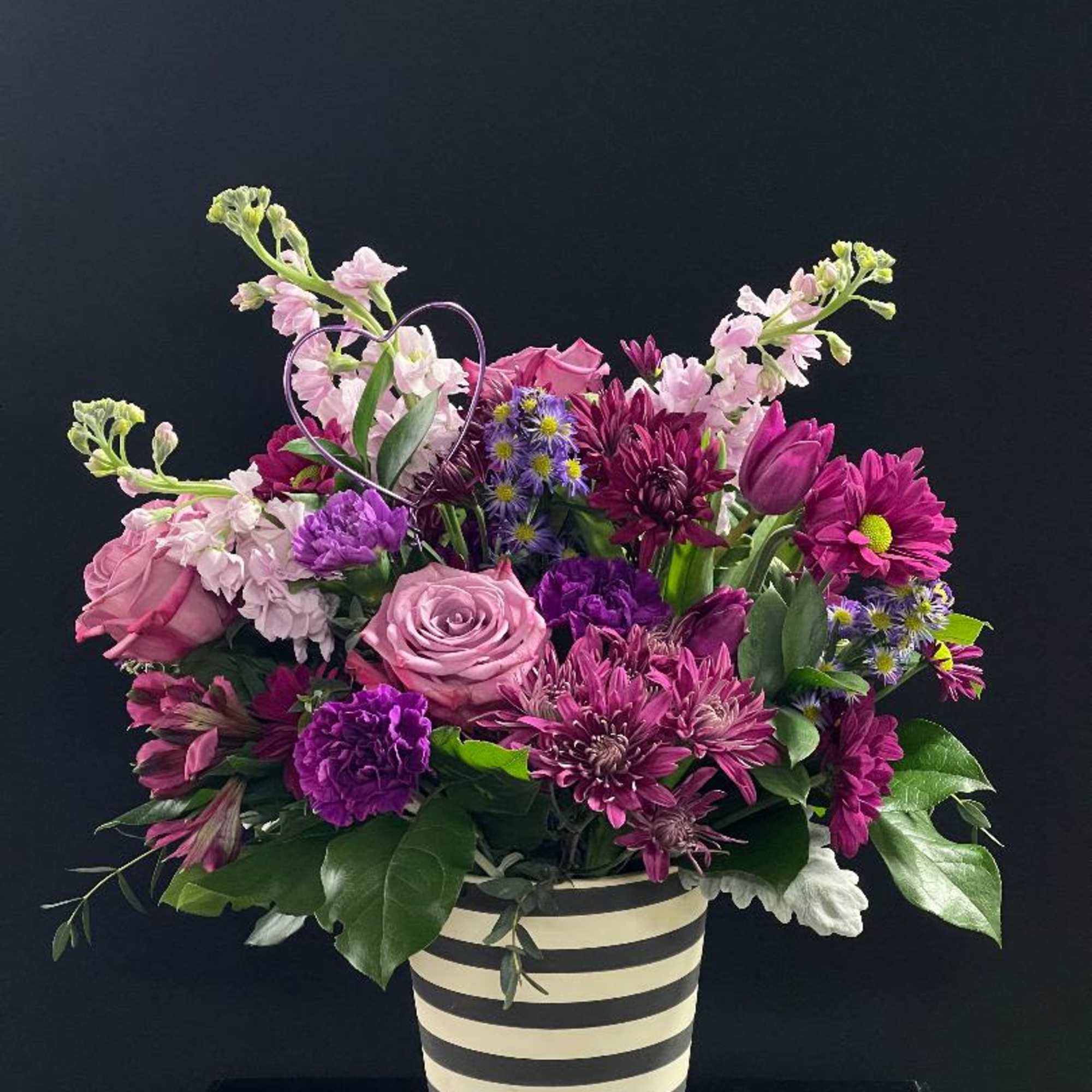 This arrangement is full of beautiful purple blooms and is perfect for