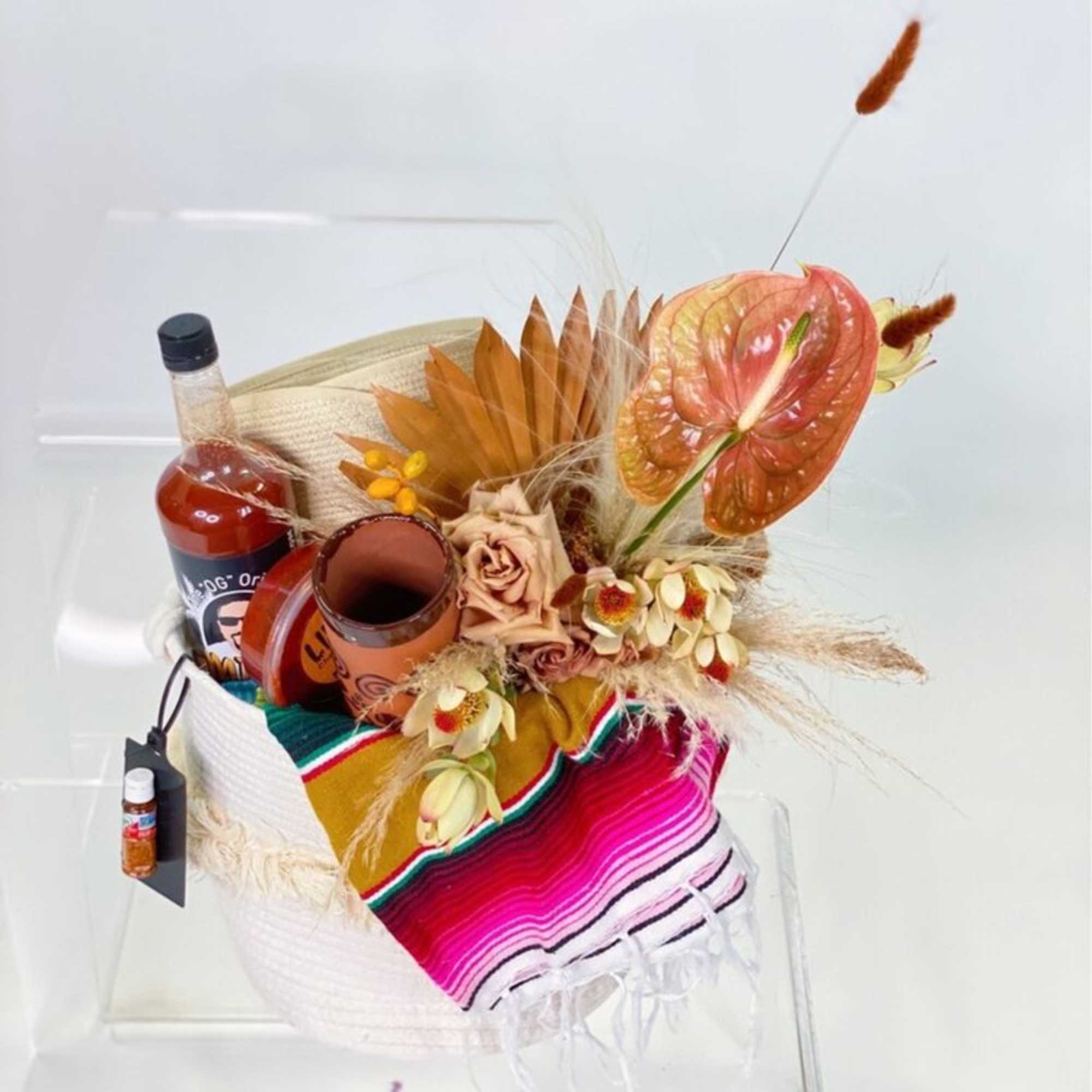 - OFF-WHITE WOVEN TOTE
- DESERT CLAY TONED FLORAL ARRANGEMENT
- CREAM SOMBRERO
- SERAPE