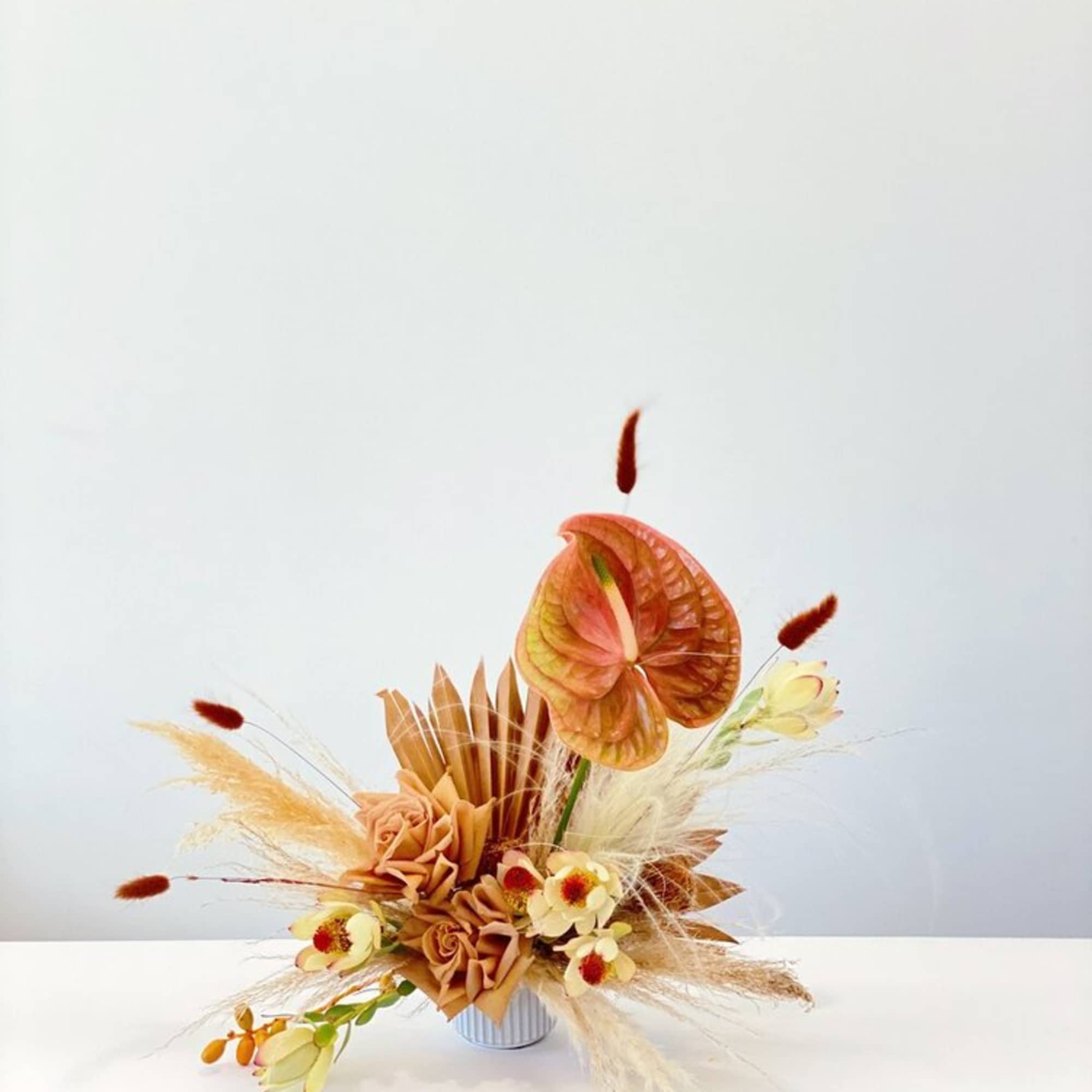 - OFF-WHITE WOVEN TOTE
- DESERT CLAY TONED FLORAL ARRANGEMENT
- CREAM SOMBRERO
- SERAPE