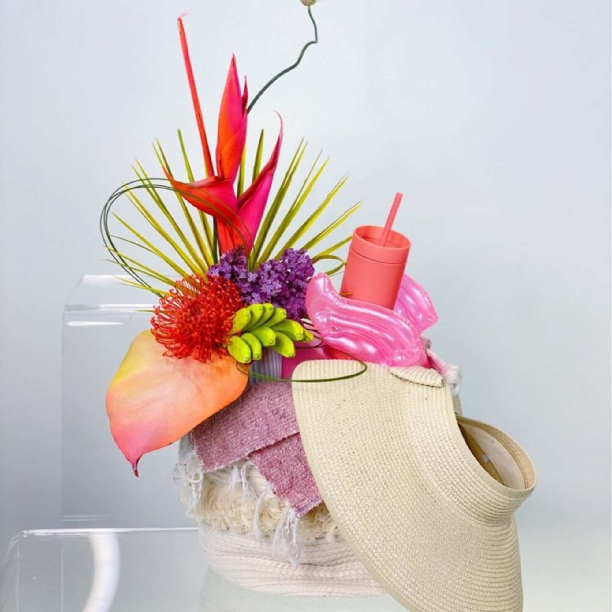 - FLORAL ARRANGEMENTS NEON TROPICAL FLORAL ARRANGEMENT
- OFF-WHITE WOVEN TOTE
- BEACH BLANKET
-