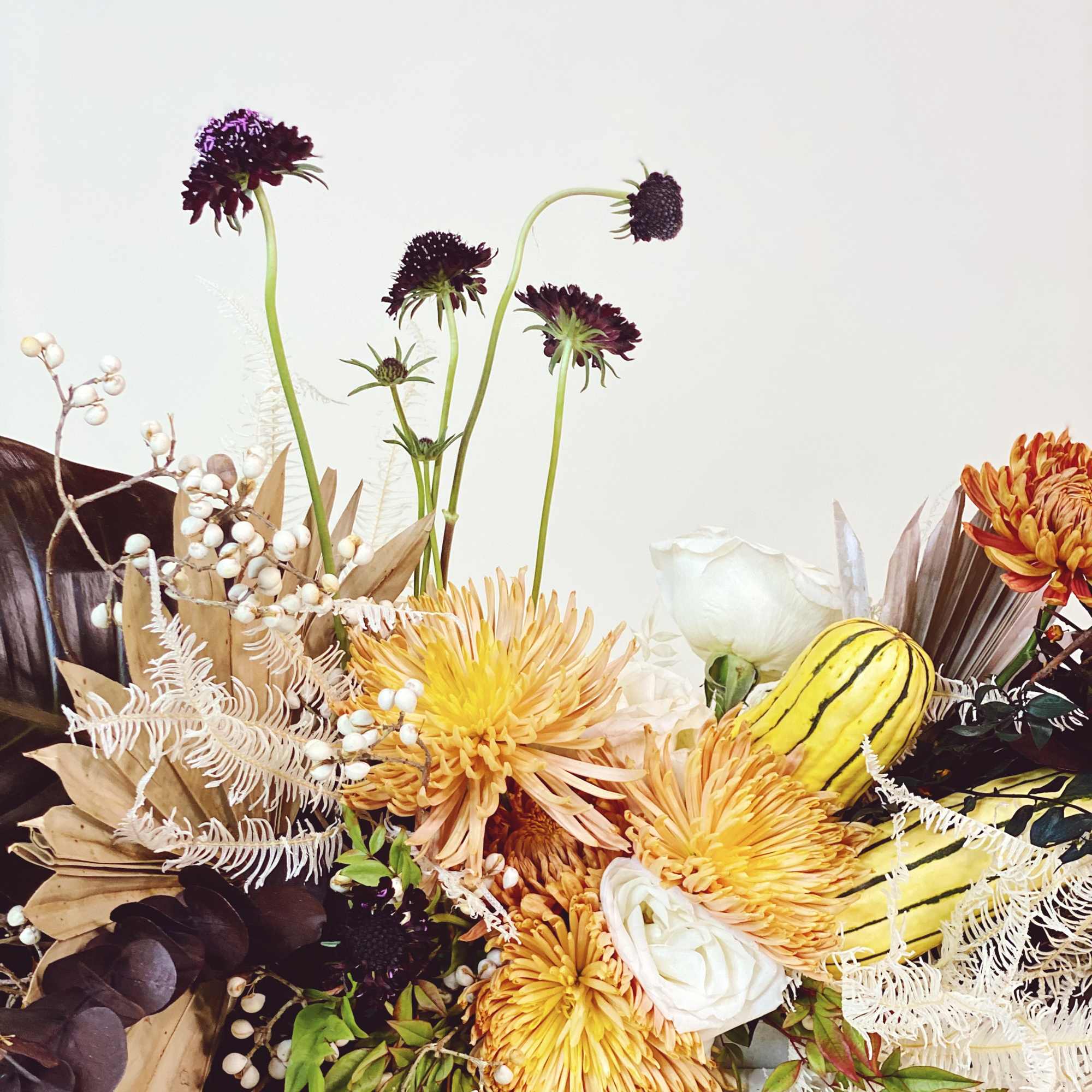 - Stunning fall arrangement with warm chrysanthemums
- Deep-toned accents and delicate white