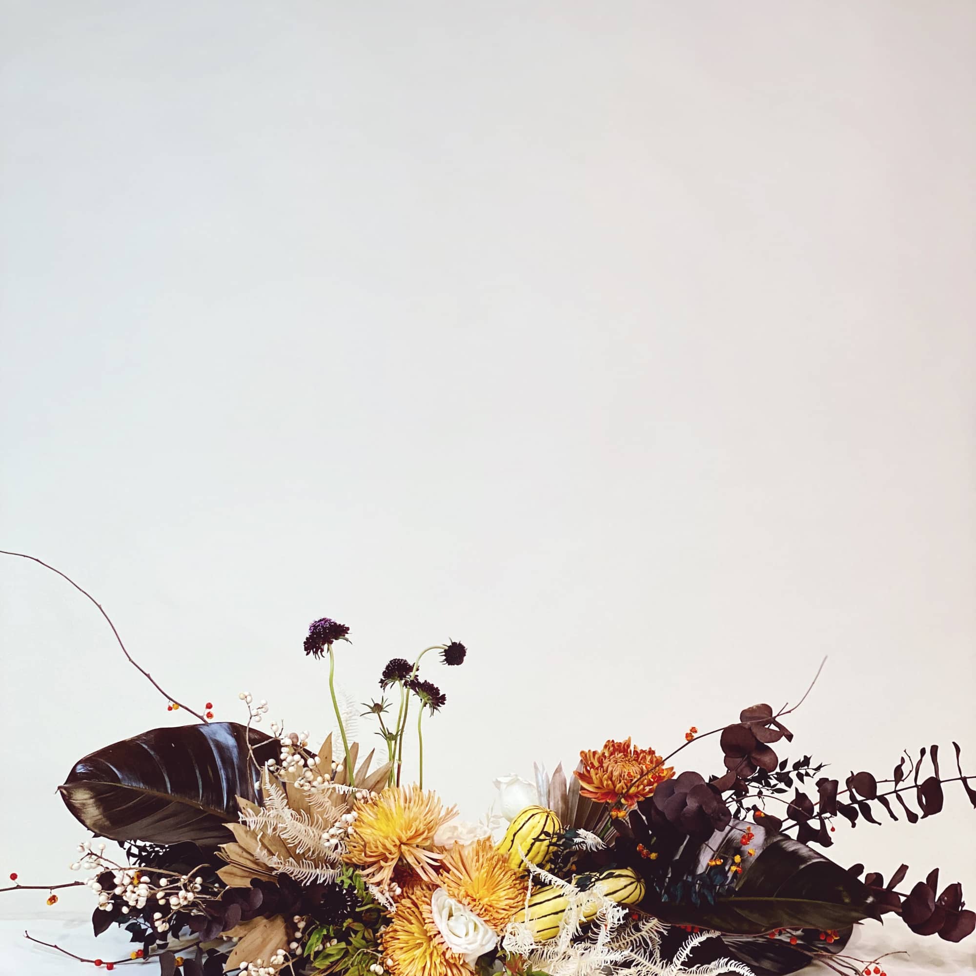 - Stunning fall arrangement with warm chrysanthemums
- Deep-toned accents and delicate white