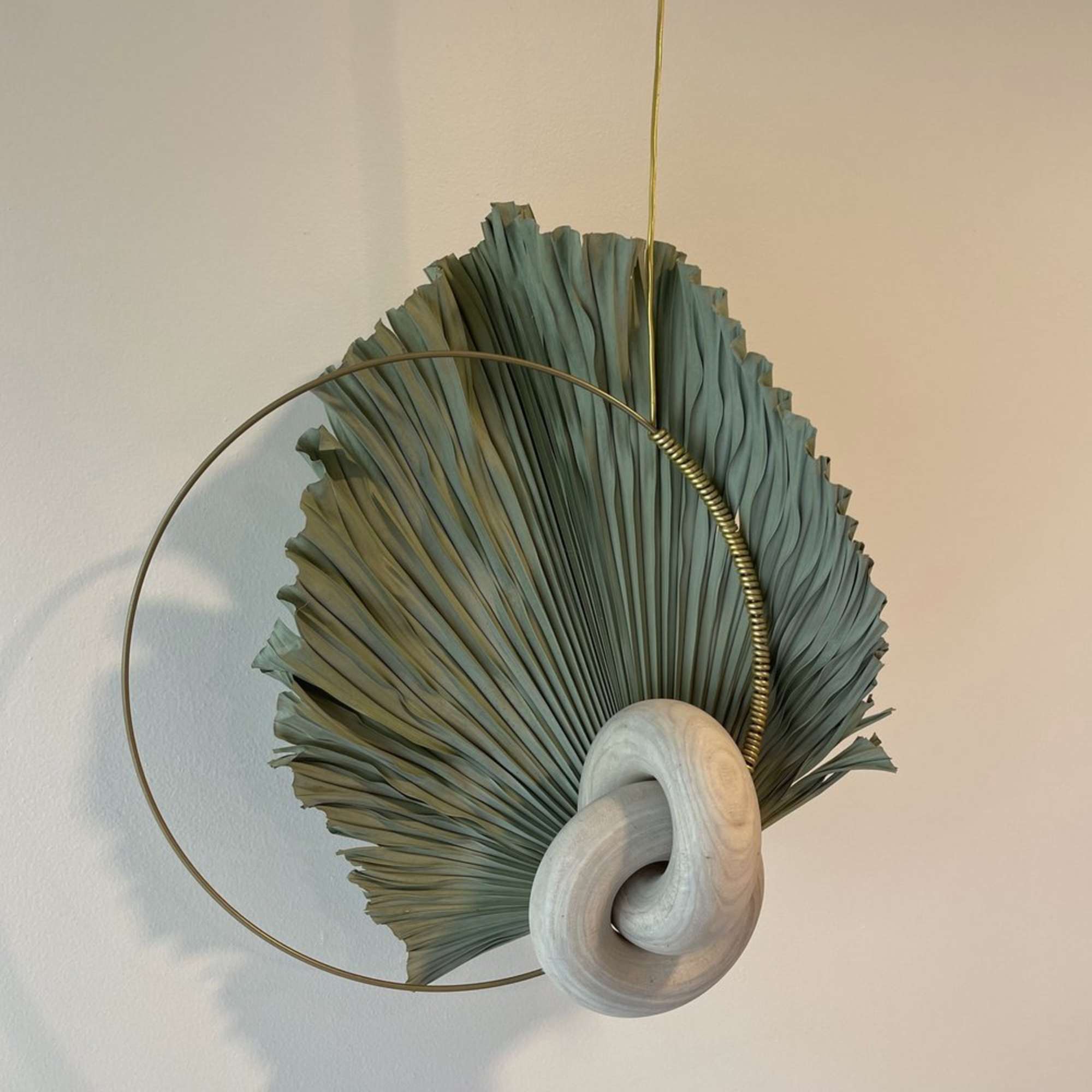 - Hanging floral arrangement blending serene neutral tones with striking dry elements
-