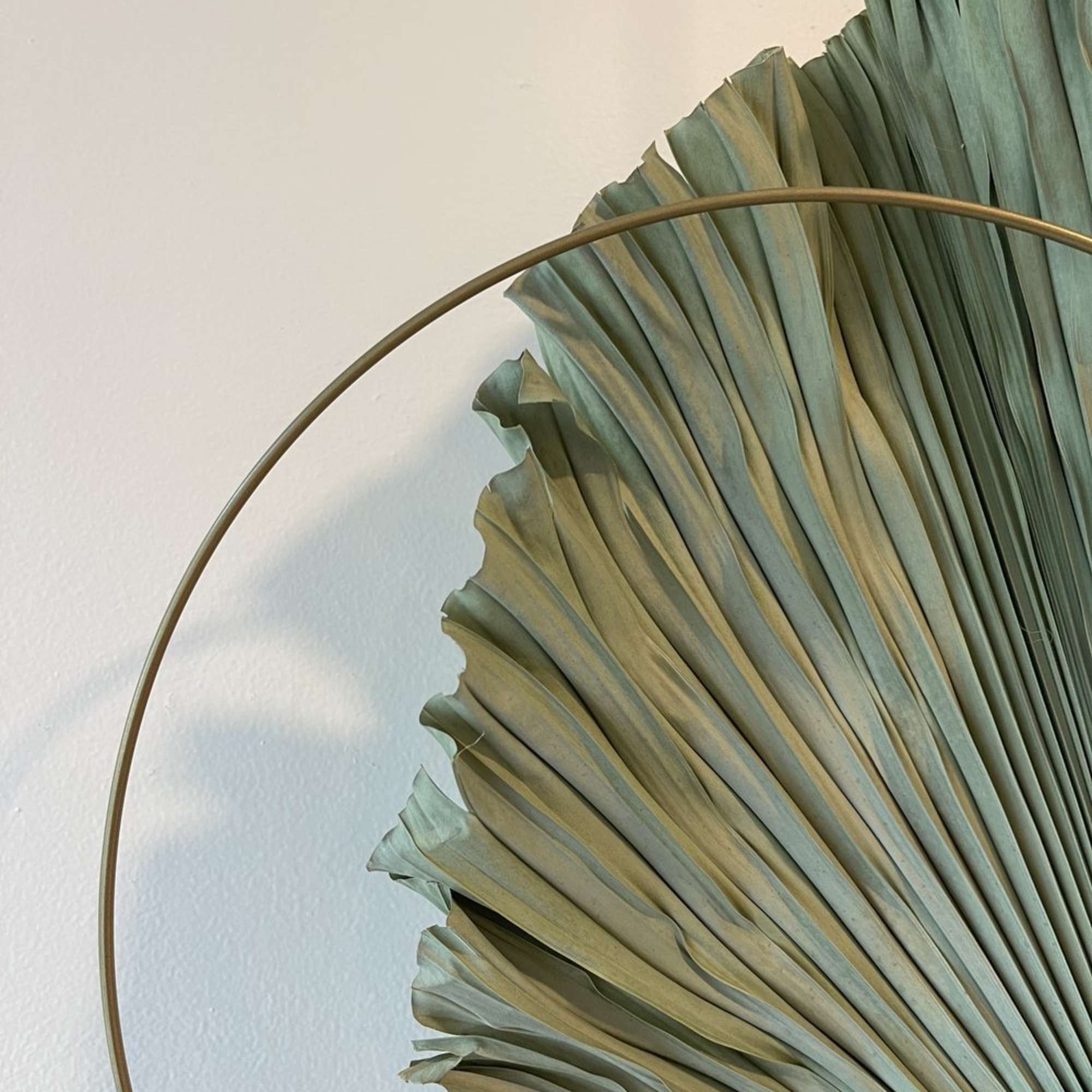 - Hanging floral arrangement blending serene neutral tones with striking dry elements
-